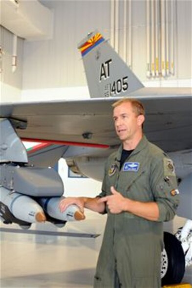 Lt. Col. Todd Seger talks about new small-diameter laser-guided bombs added to an early model F-16 Fighting Falcon during the Weapons and Tactics Conference Oct. 20, 2010, in Tucson, Ariz.  Guard and Reserve warfighters were at the conference to provide input for improving the capability of legacy aircraft. Colonel Seger is a test pilot and the combined test force director for the Air National Guard- Air Force Reserve Command Test Center, or AATC, at Tucson, one of the hosts for the conference.  (U.S. Air Force photo/Maj. Gabe Johnson) 