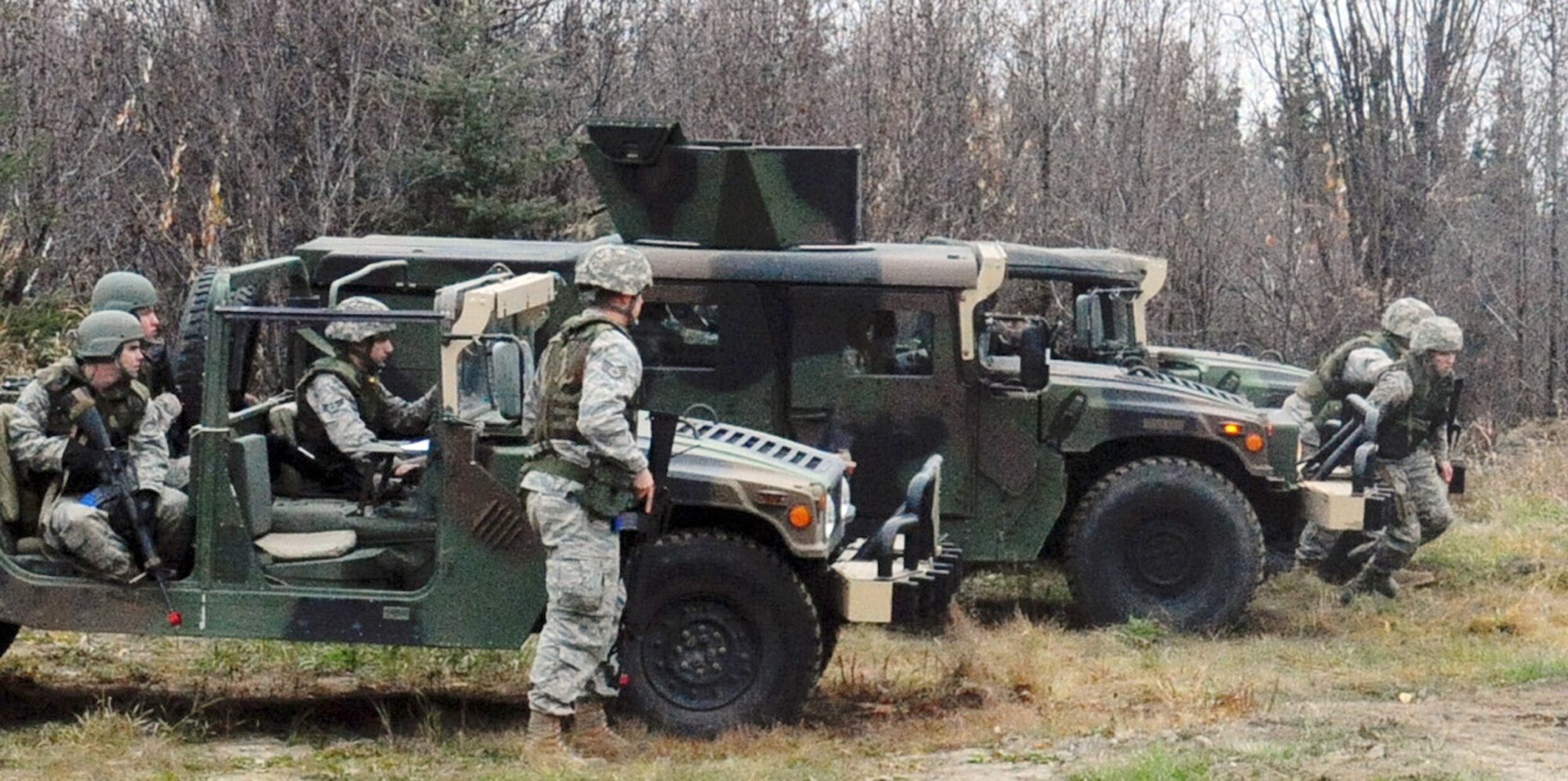 Airmen rush to "rescue" comrades during a convoy preparedness exercise Oct. 7, 2010, at Eielson Air Force Base, Alaska. The 354th Civil Engineering Squadron Explosive Disposal Flight conducts the training to increase understanding of improvised explosive devices for deploying Airmen.  (U.S. Air Force photo/Airman 1st Class Laura Goodgame)