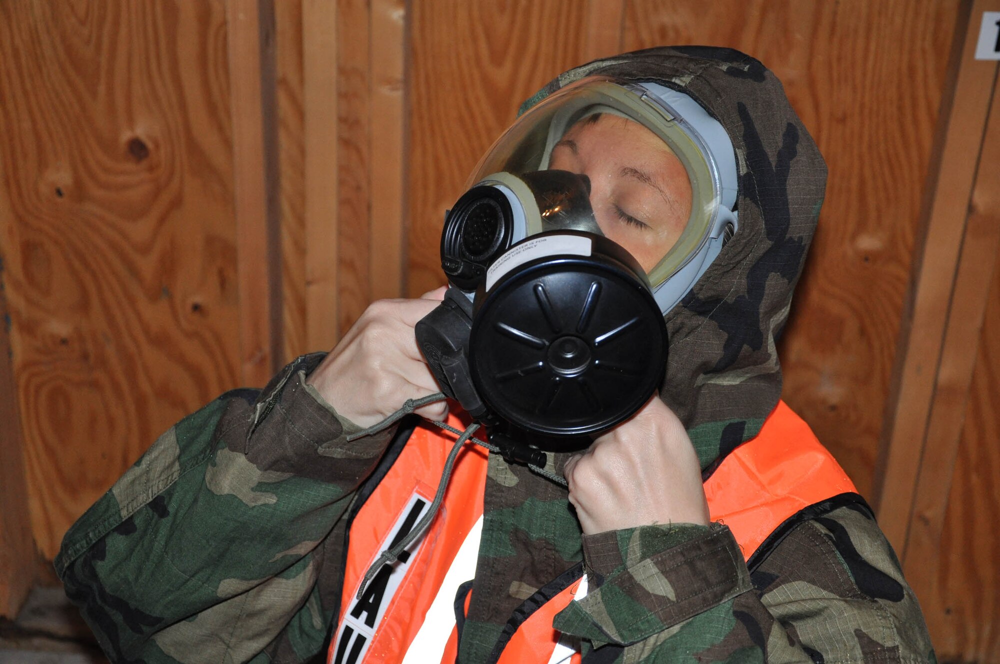 WRIGHT-PATTERSON AIR FORCE BASE, Ohio – A reservist assigned to the 445th Aeromedical Staging Squadron dons a gas mask during a training exercise Oct. 2.  More than 100 Airmen completed ATSO (the ability to survive and operate) training during the October unit training assembly that included mission oriented protective postures, alarm conditions, and force protection actions.  The group also participated in flu outbreak, security issues and medical recovery exercises. (U.S. Air Force photo/Senior Airman Matthew Cook)