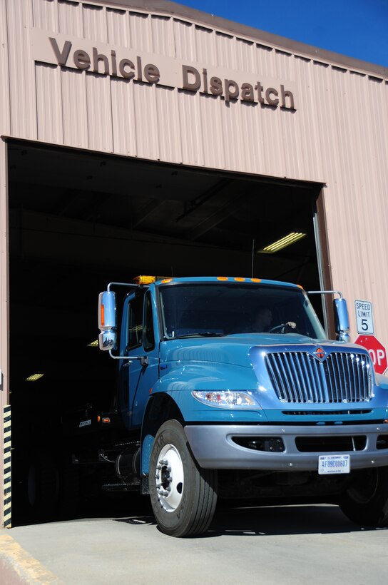 ELLSWORTH AIR FORCE BASE, S.D. -- Airman 1st Class Gregory Hulett, 28th Logistics Readiness Squadron, vehicle operator, drives a flatbed truck out of the vehicle dispatch garage, Oct. 6.  Vehicle dispatch Airmen train for convoy operations which they perform downrange that add Army tactics, techniques and procedures to the mix. (U.S. Air Force photo/Airman 1st Class Anthony Sanchelli)