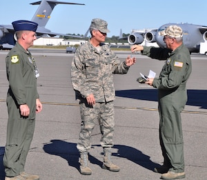 Major General Martin Mazick (right), vice commander for the Air Force Reserve Command, presents Colonel Steven Chapman (center), commander of the 315th Airlift Wing, the symbolic keys to the newest C-17 arriving at Joint Base Charleston.  Maj. Gen. Mazick and Col. Chapman are joined by Col. John Wood, commander of the 437th Airlift Wing (U.S. Air Force photo/Staff Sgt. Shane Ellis)
