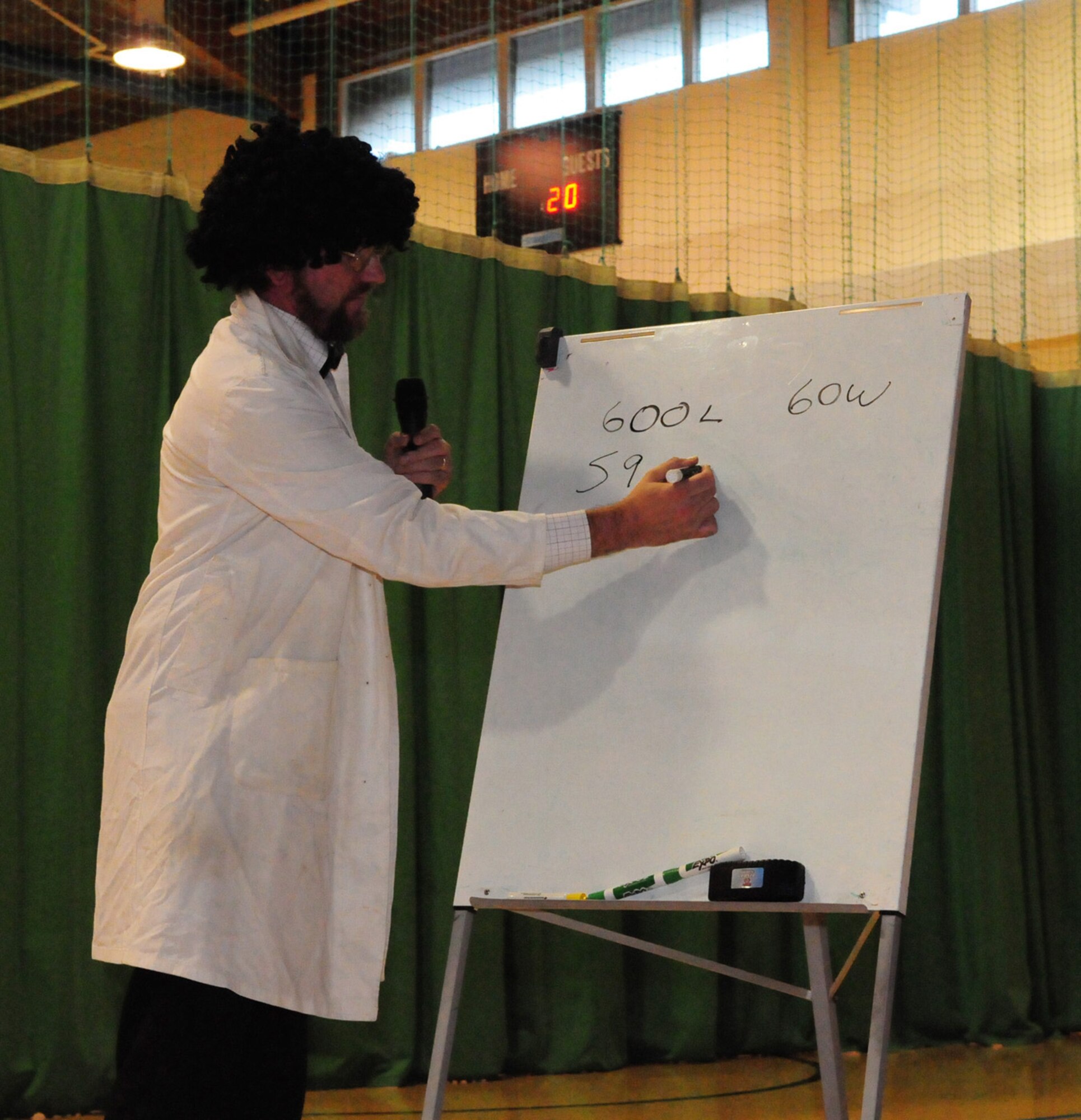 RAF MILDENHALL, England -- "Professor Perry" (Steve Perry, 100th Civil Engineer Squadron) writes down different light values as he talks about old-style and energy-efficient lightbulbs to children at the youth center Oct. 22, as part of Energy Awareness Month. Mr. Perry conducted fun experiments with the children, to help and encourage them to learn more about energy awareness. (U.S. Air Force photo/Karen Abeyasekere)
