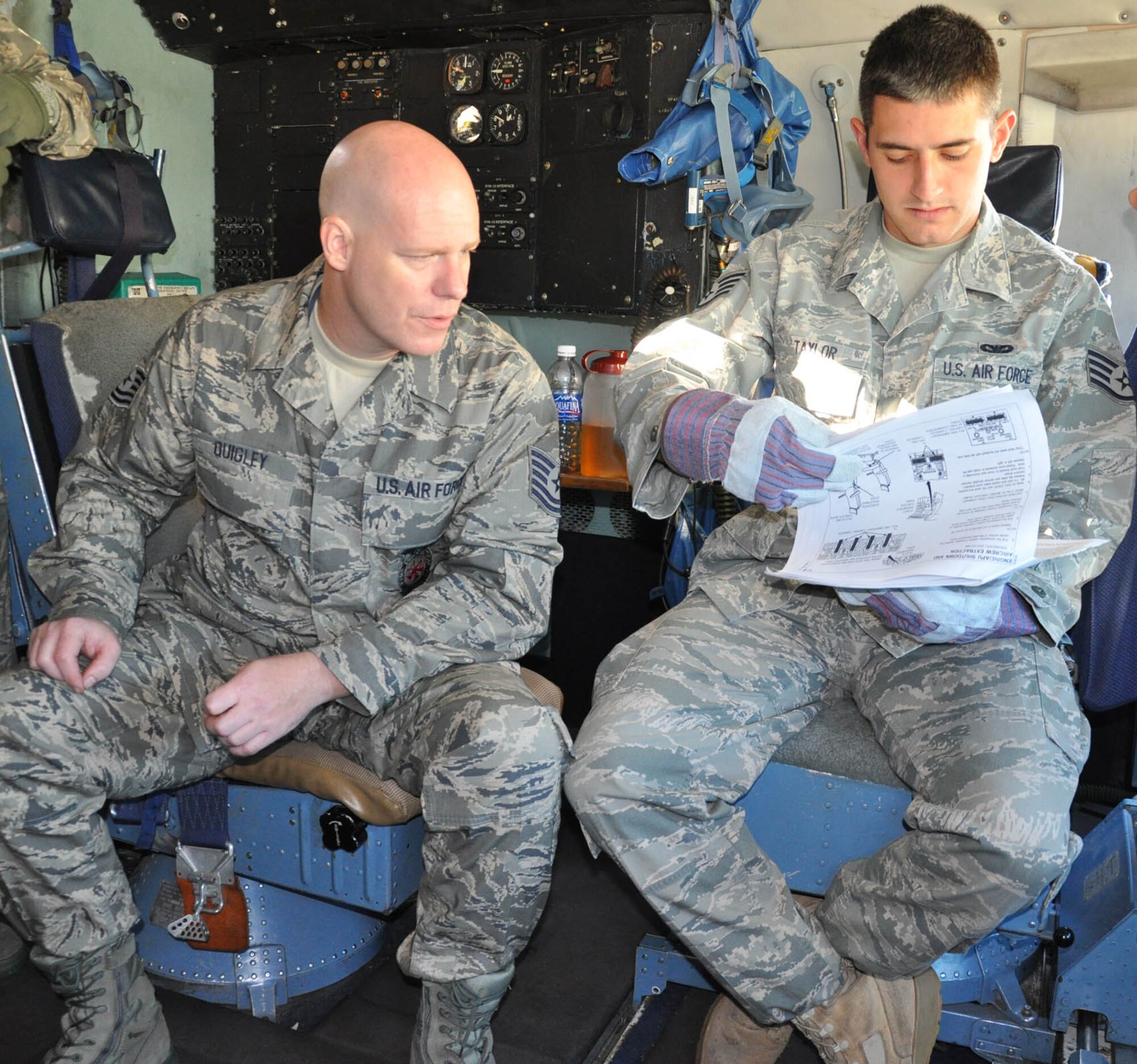 WRIGHT-PATTERSON AIR FORCE BASE, Ohio – Tech. Sgt. Dale Quigley looks on as Staff Sgt. Christopher Taylor pages through the emergency shutdown procedures for a C-5 Galaxy as part of a training exercise performed during the Oct. 17 unit training assembly.  Both are firefighters assigned to the 445th Civil Engineer Squadron. (U.S. Air Force photo/Senior Airman Mikhail Berlin)