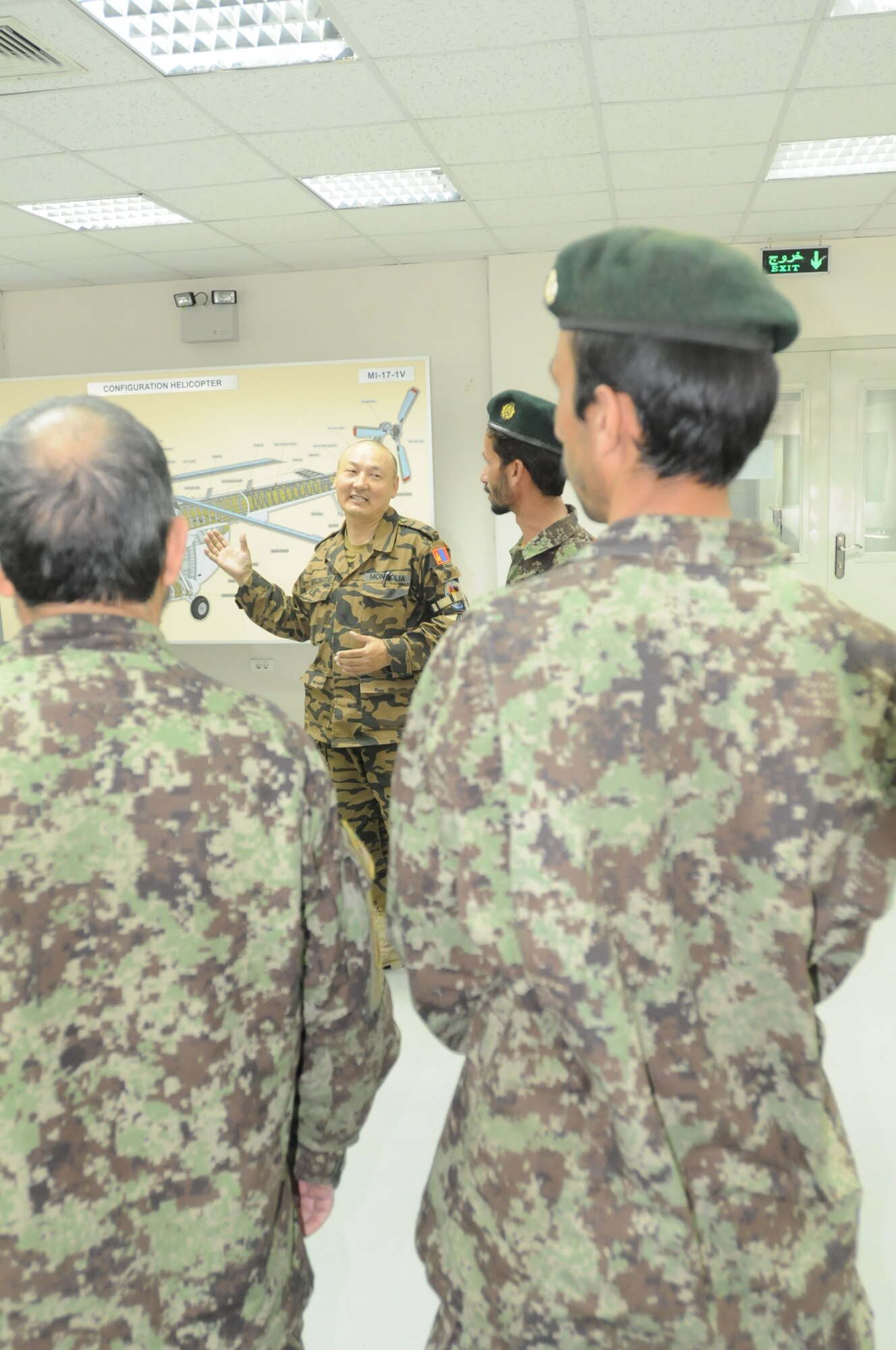 Lt. Col. Chogdon Boldbaatar, officer in charge of Afghan Advising team from Mongolia, introduces himself and his team to Afghan students.  The class will teach fundamental of the Mi-17 transport helicopter which the Afghans maintain and fly in the Afghan Air Force.