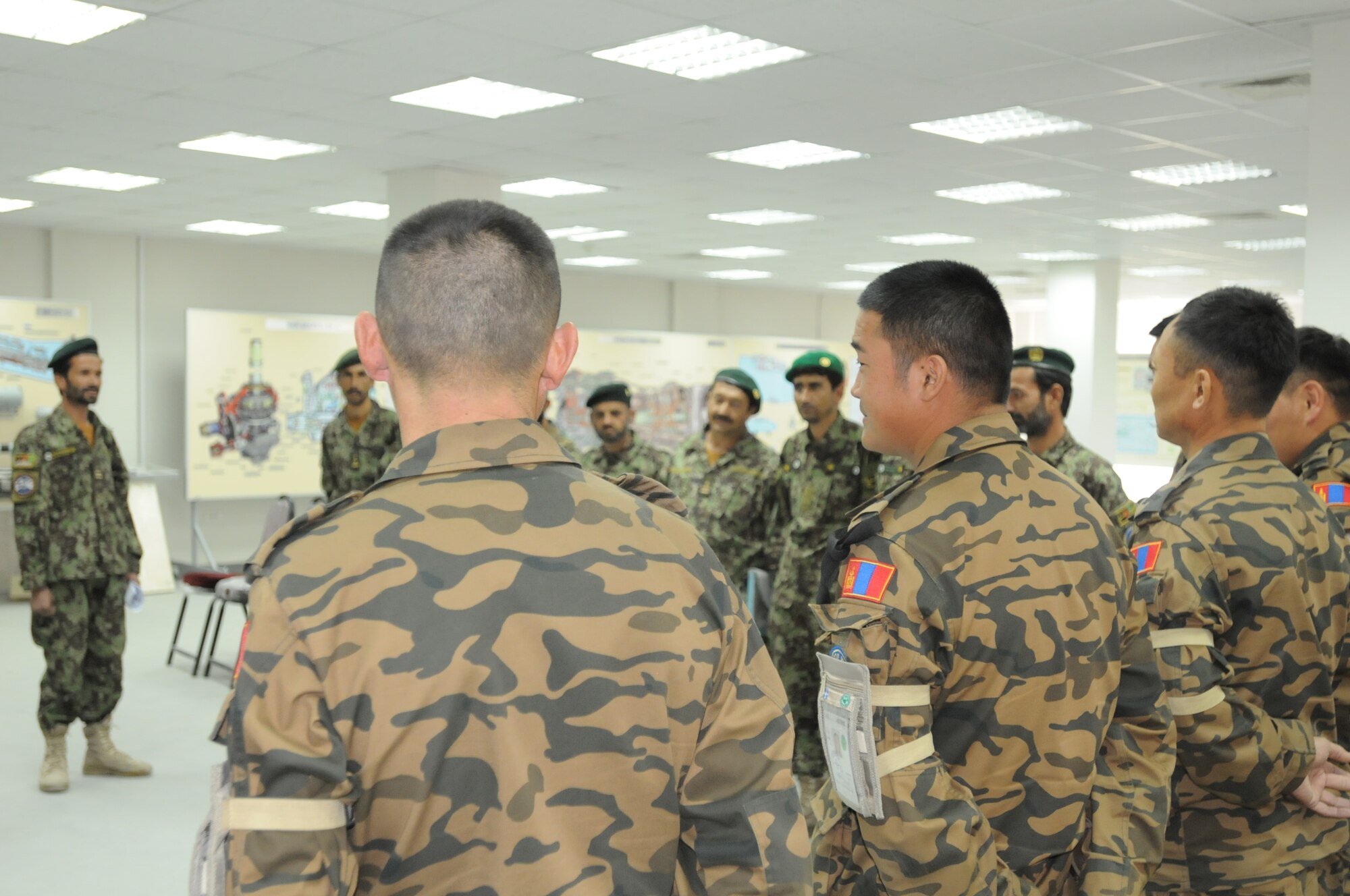 Lt. Col. Chogdon Boldbaatar, officer in charge of Afghan Advising team from Mongolia, introduces himself and his team to Afghan students.  The class will teach fundamental of the Mi-17 transport helicopter which the Afghans maintain and fly in the Afghan Air Force.