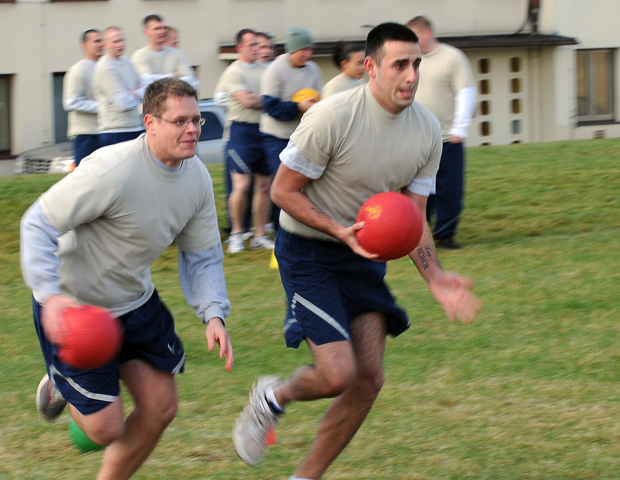 SPANGDAHLEM AIR BASE, Germany – Staff Sgt. Levi Williams, left, 52nd Force Support Squadron Airman Leadership School instructor, runs alongside teammate Senior Airman Sean Heron, 52nd Operations Support Squadron ALS student, during a game of Icarus Oct. 20. The game was introduced to the ALS class as an opportunity to teach the young enlisted members about air and space principles along with the fundamentals of leadership, followership and teamwork. (U.S. Air Force photo/Airman 1st Class Matthew B. Fredericks)