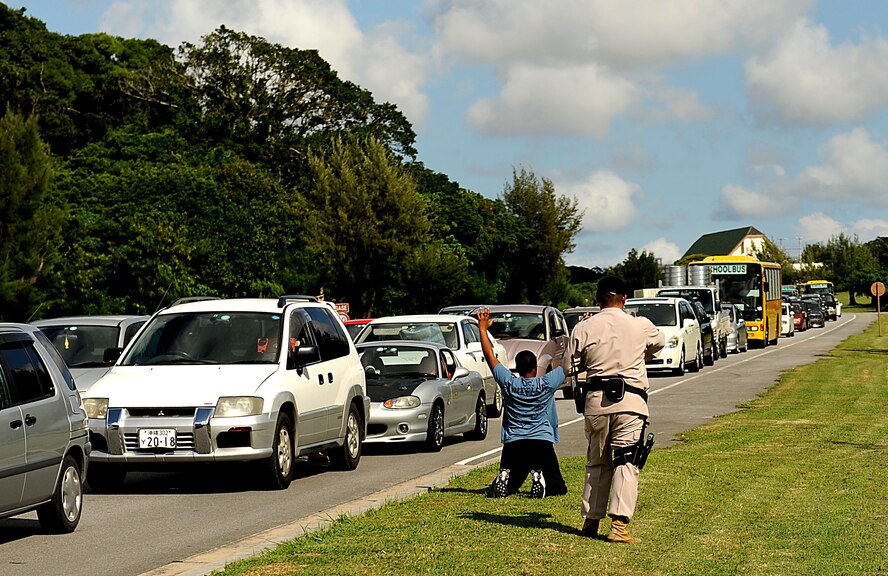 Airman 1st Class Alyssa Hayes is apprehended by members of the 18th Security Forces Squadron after attempting to flee the base following a "bank robbery" during an exercise. She and her fellow thieves were caught attempting to leave the main gate, where traffic was stopped due to alarm activation.  Kadena Air Base personnel are participating in Exercise Beverly High 11-01 to stay prepared for real world contingencies. (US Air Force photo/Staff Sgt. Christopher Hummel)