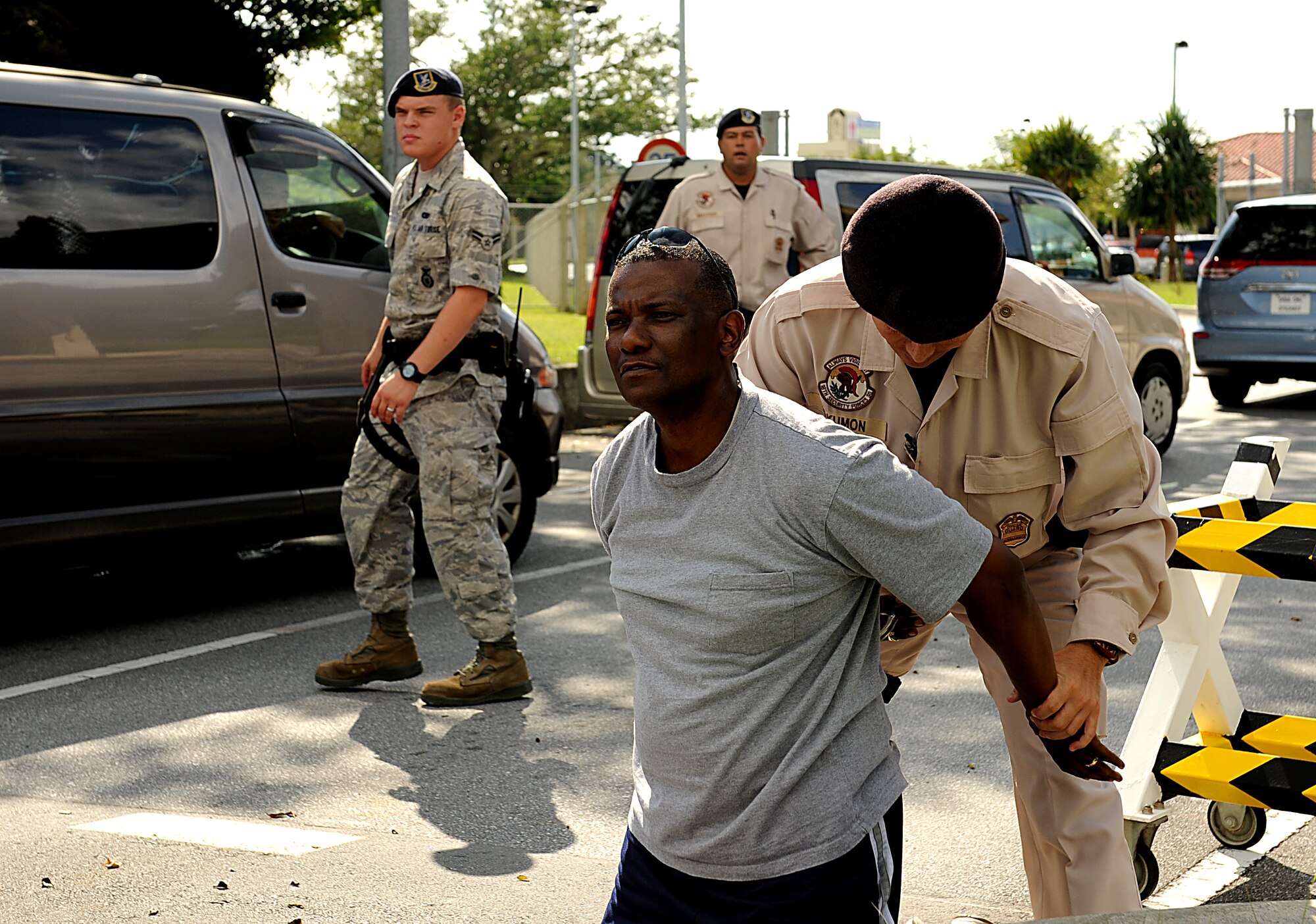 Senior Master Sgt. Gary Sapp, 18th Security Forces Squadron First Sergeant, is apprehended after "robbing" a bank as part of an exercise, Oct. 25, Kadena Air Base, Japan. Kadena personnel are participating in Exercise Beverly High 11-01 to stay prepared for real world contingencies. (US Air Force photo/Staff Sgt. Christopher Hummel)