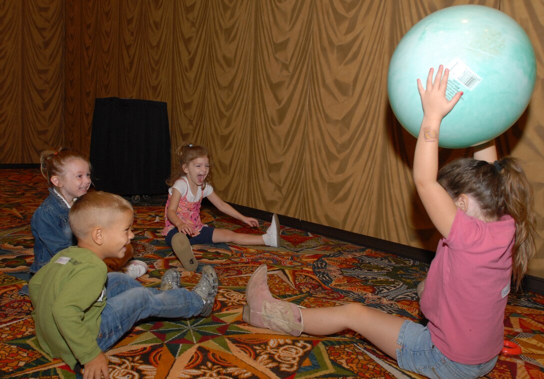 Children play ball while their parents, soldiers of the 72nd Infantry Brigade Combat Team, attend a Yellow Ribbon Reintegration Program event in Houston, Texas, Oct. 17, 2010. The Defense Department created the Yellow Ribbon program to ensure reserve-component servicemembers have access to the information and resources they need to reintegrate with their families, their communities and their employers effectively after a deployment. DOD photo by Elaine Wilson