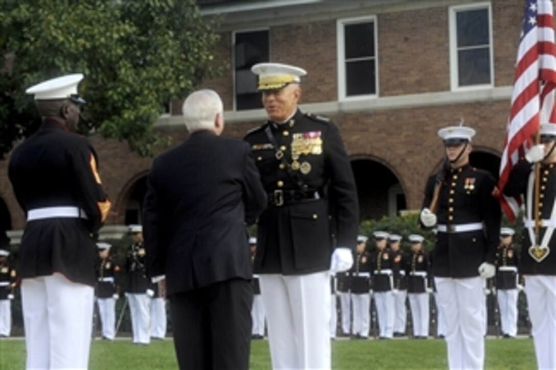 Secretary of Defense Robert M. Gates presents an award to Gen. James T. Conway during a Passage of Command of the United States Marine Corps ceremony at the Marine Barracks, Washington, D.C., on Oct. 22, 2010.  Conway relinquished command as Commandant of the Marine Corps to Gen. James F. Amos in a ceremony presided over by Gates.  