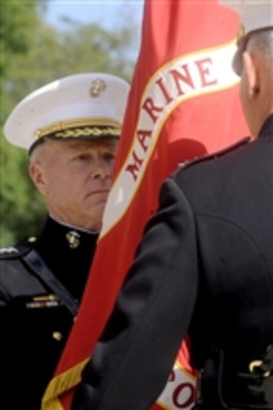 The 35th Commandant of the Marine Corps Gen. James F. Amos accepts command from Gen. James T. Conway during a Passage of Command ceremony presided over by Secretary of Defense Robert M. Gates at the Marine Barracks, Washington, D.C., on Oct. 22, 2010.  