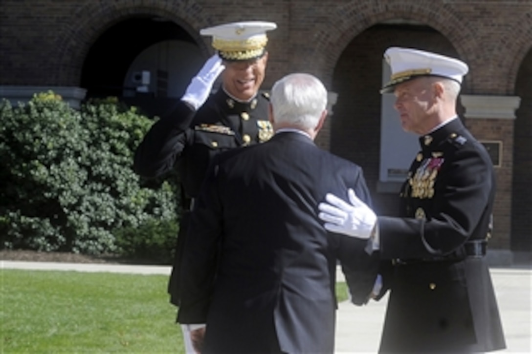 Secretary of Defense Robert M. Gates congratulates the 35th Commandant of the Marine Corps Gen. James F. Amos (right) and the 34th Commandant of the Marine Corps Gen. James T. Conway during a Passage of Command ceremony at the Marine Barracks, Washington, D.C., on Oct. 22, 2010.  