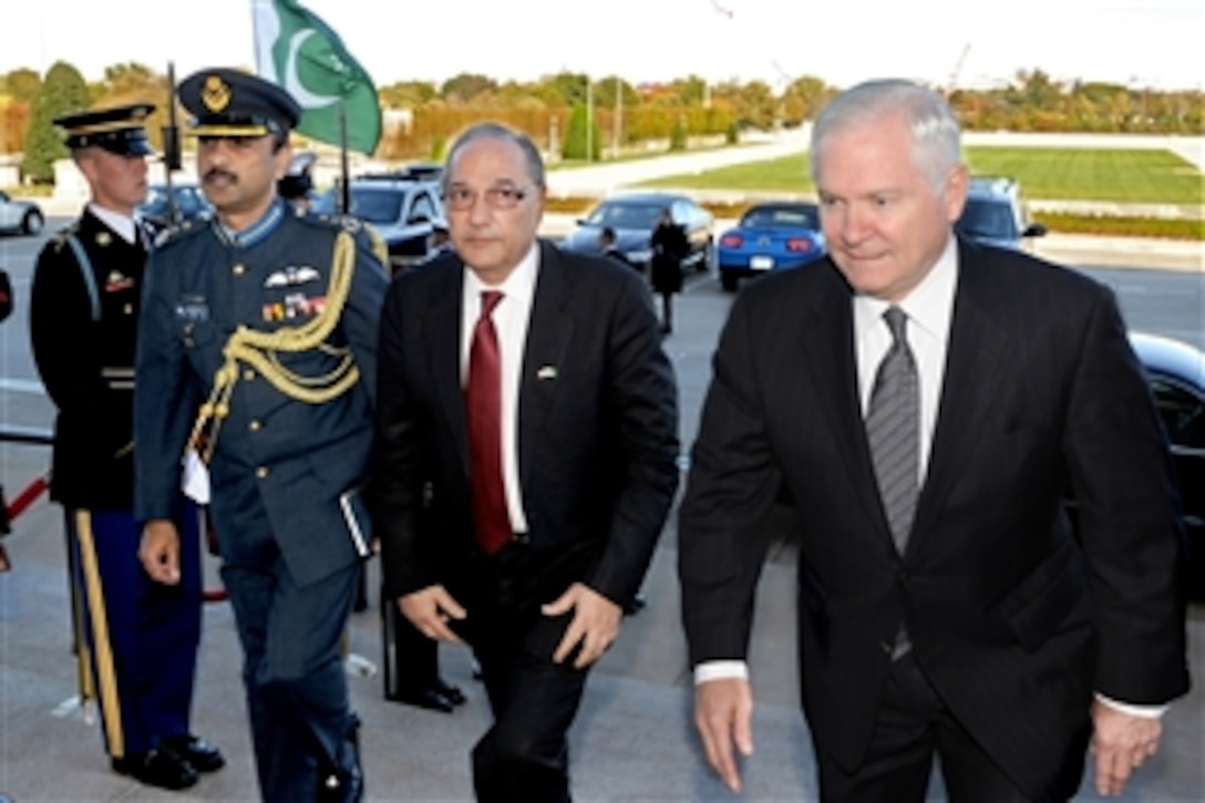 Secretary of Defense Robert M. Gates (right) escorts Pakistani Defense Minister Chaudhry Ahmed Mukhtar (2nd from right) through an honor cordon and into the Pentagon on Oct. 22, 2010.  Gates and Mukhtar will meet to discuss a broad range of issues relating to the prosecution of the ongoing war in neighboring Afghanistan.  Mukhtar is accompanied by Pakistani Air Force Group Capt. Ahmer Shehzad, air attach‚ at the Pakistan Embassy in Washington, D.C.  