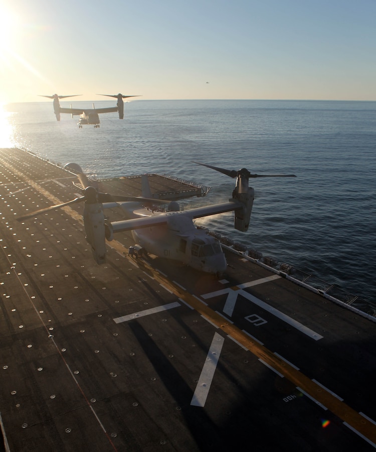 USS IWO JIMA (LHD 7) –Two MV-22 Ospreys from  Marine Medium Tiltrotor Squadron VMM-261 (Reinforced), 24th Marine Expeditionary Unit,  land on the amphibious assault ship USS Iwo Jima Oct. 25, 2011, during the 24th MEU’s first at sea period with Amphibious Squadron 8 (PHIBRON 8).  The landings are part of the qualification process for the pilots during the PHIBRON/MEU Integration Exercise, known as PMINT.  PMINT will take place Oct. 24 to Nov. 3 and is focused on building the Navy-Marine Team and establishing the working relationships necessary to conduct operations from the sea.  The MV-22 Ospreys are home based at Marine Corps Air Station New River, N.C.  (Official USMC Photo by: GySgt Chad R. Kiehl/ Released)