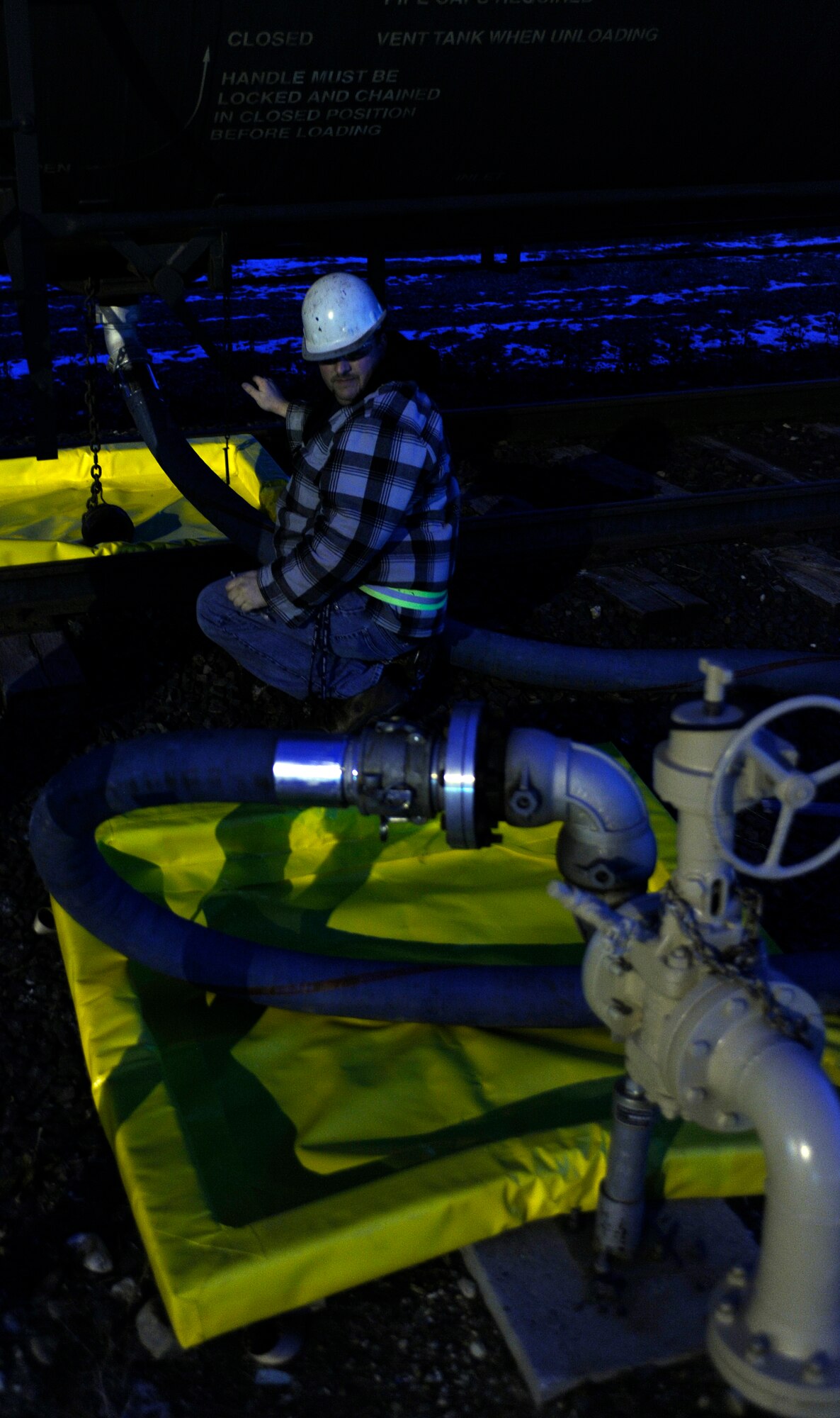 A government contractor pumps fuel Oct. 25, 2010, Eielson Air Force Base, Alaska. Contractors come to Eielson to empty the rail cars filled with fuel and to provide new Airmen with training on proper fuel transfer procedures. The contractors work with the 354th Logistics Readiness Squadron. (U.S. Air Force photo/Senior Airman Willard E. Grande II)
