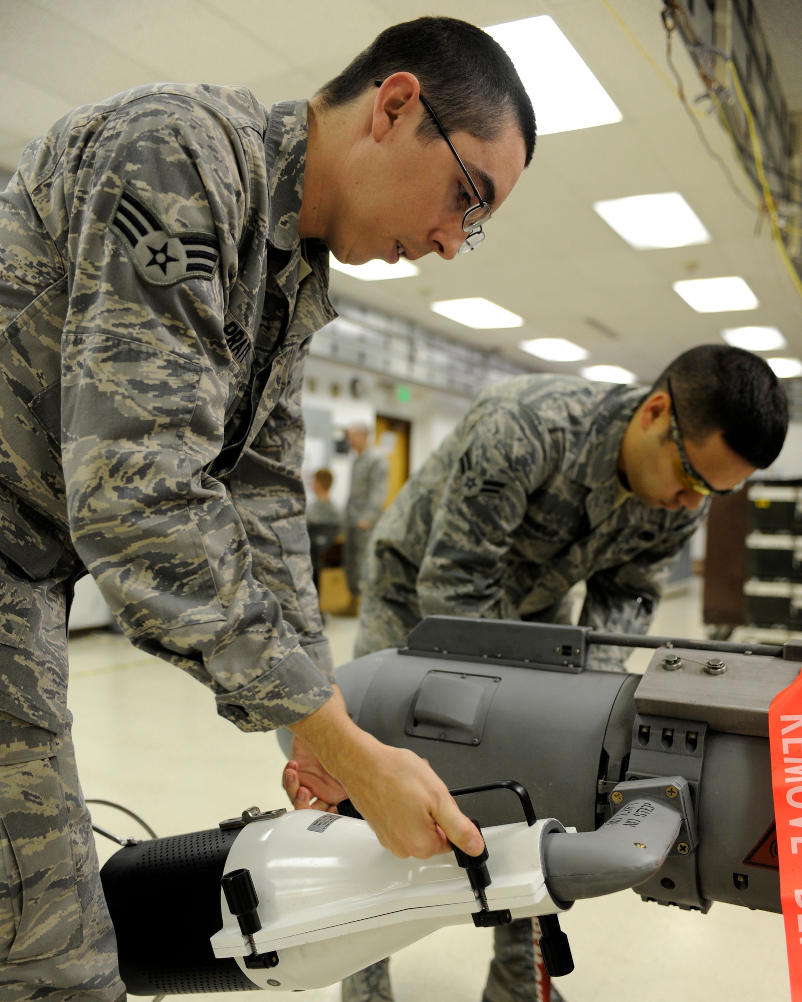 Senior Airman Levi Pratt and Airman 1st Class Daniel Chandler install radio frequency emissions inhibitors Oct. 22, 2010, Eielson Air Force Base, Alaska. The inhibitors protect Airman from potentially harmful RF emitted during testing of the AN/ALQ 188 Electronic Counter Measure Pod. Airmen Pratt and Chandler are electronic warfare team members assigned to the 354th Maintenance Group. (U.S. Air Force photo/Senior Airman Willard E. Grande II)