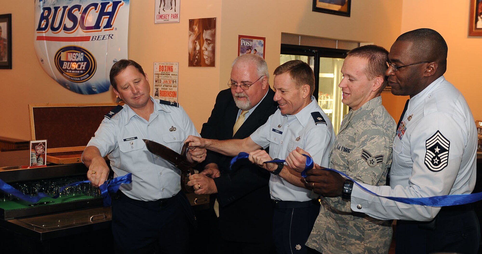 NELLIS AIR FORCE BASE, Nev.--  Members from Nellis cut the grand opening ribbon to the Timeout Sports Lounge, located inside the Desert Oasis Club Oct. 25. The sports lounge was designed for Airmen of all ranks and provides various options for entertainment. (U.S Air Force Photo / Senior Airman Stephanie Rubi)