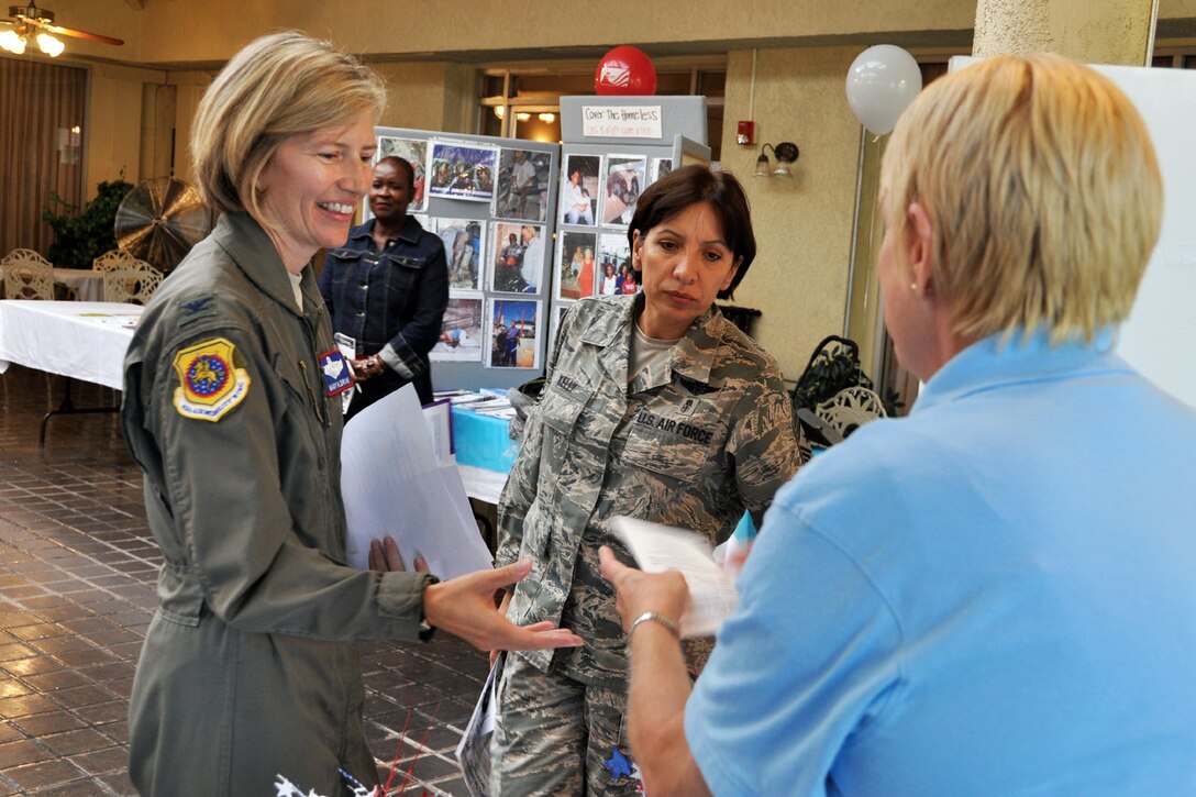 Col. Mary Aldrian, 452nd Air Mobility Wing vice commander, and Command Chief Master Sgt. Ericka Kelly, speak with a representative from Veterans First at the Combined Federal Campaign Fair Oct. 19 at the Hap Arnold Club. Veterans First is a nonprofit agency based in Santa Ana, Calif., that provides exclusive services to homeless veterans and their families. (U.S. Air Force photo by Linda Welz)
