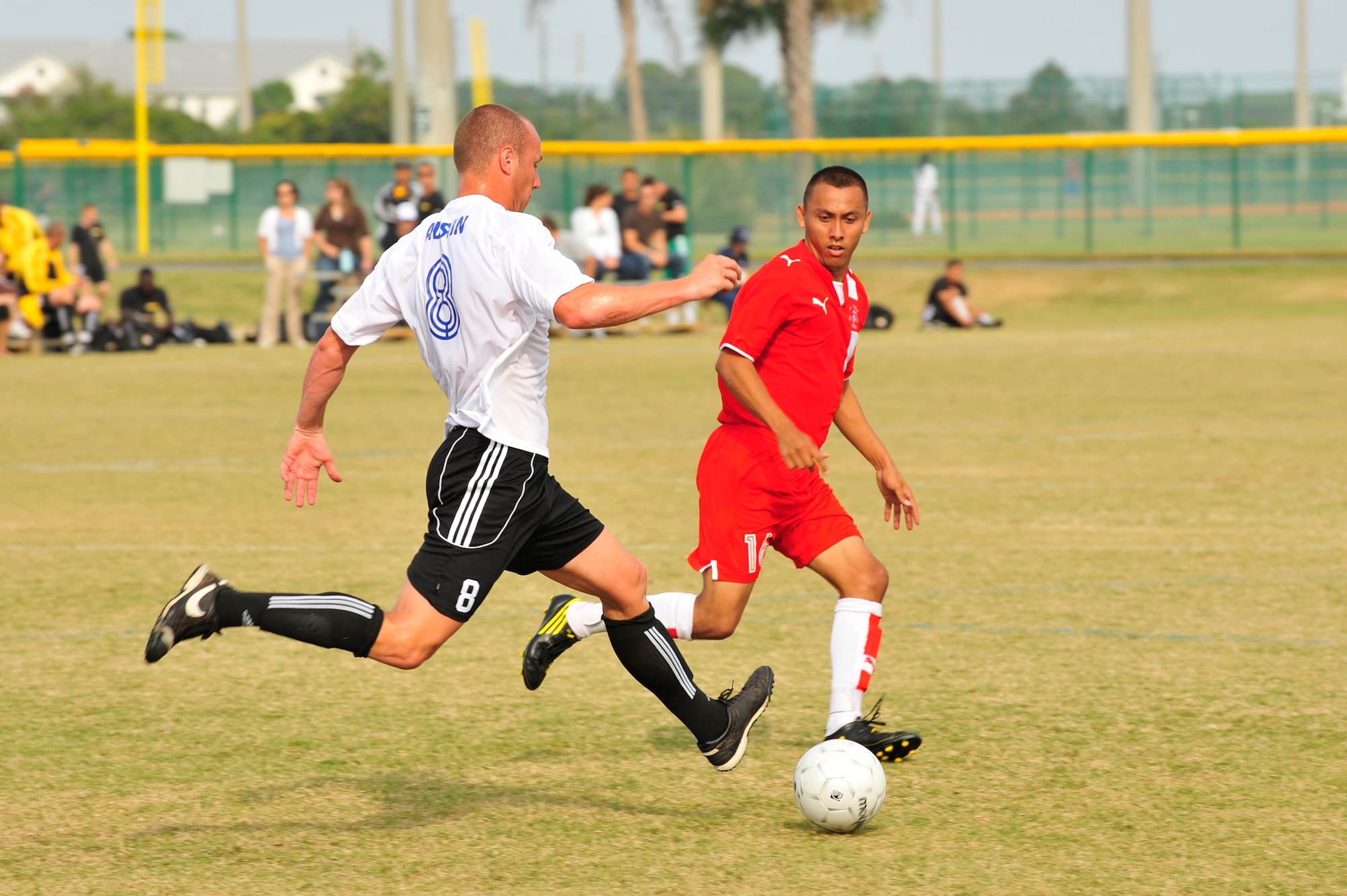 U.S. Air Force Senior Airman Paul Austin dribbles the ball downfield while U.S. Marine Corps Sgt. Erik Martinez tries to recover the ball during an Armed Forces Men's Soccer Championship match at the Morgan Sports Complex, Destin, Fla., Oct. 24, 2010. The Armed Forces Championships are conducted by the Armed Forces Sports council for the purpose of promoting, understanding, goodwill, and competition among the Armed Services. Senior Airman Austin is stationed at Travis AFB, Calif. Sergeant Martinez is stationed at Camp Pendleton, Calif. (DoD Photo by Staff Sgt. Stephanie Jacobs/RELEASED)

