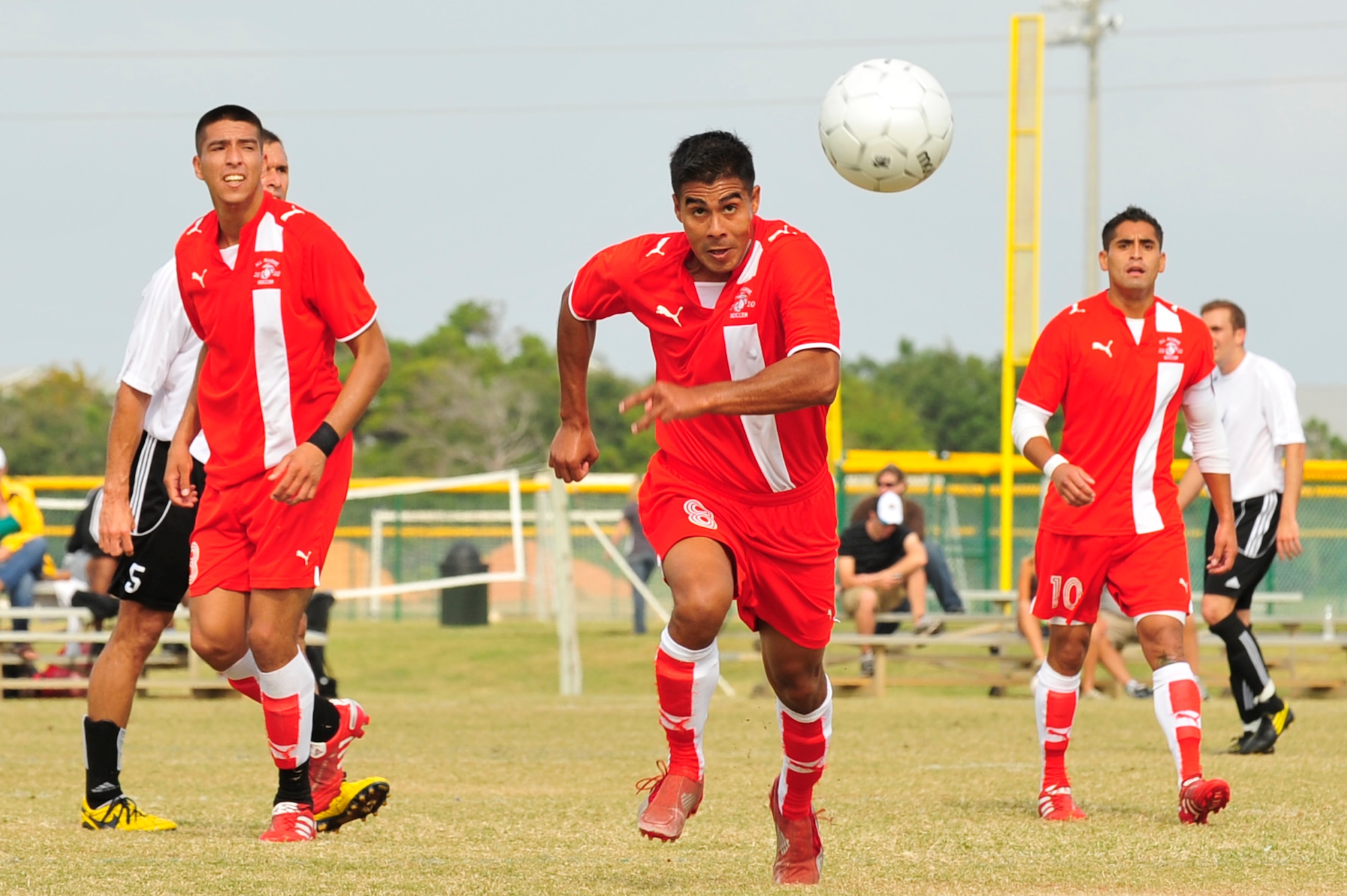 U.S. Marine Corps Lance Cpl. Kyende Bormentar runs to gain possession of the ball while Cpl. Jose Guitterez (left) and Sgt. Alberto Reategui (right) prepare to assist during an Armed Forces Men's Soccer Championship match against the U.S. Air Force at Morgan Sports Complex, Destin, Fla., Oct. 24, 2010. The Armed Forces Championships are conducted by the Armed Forces Sports council for the purpose of promoting, understanding, goodwill, and competition among the Armed Services. (DoD Photo by Staff Sgt. Stephanie Jacobs/RELEASED)

