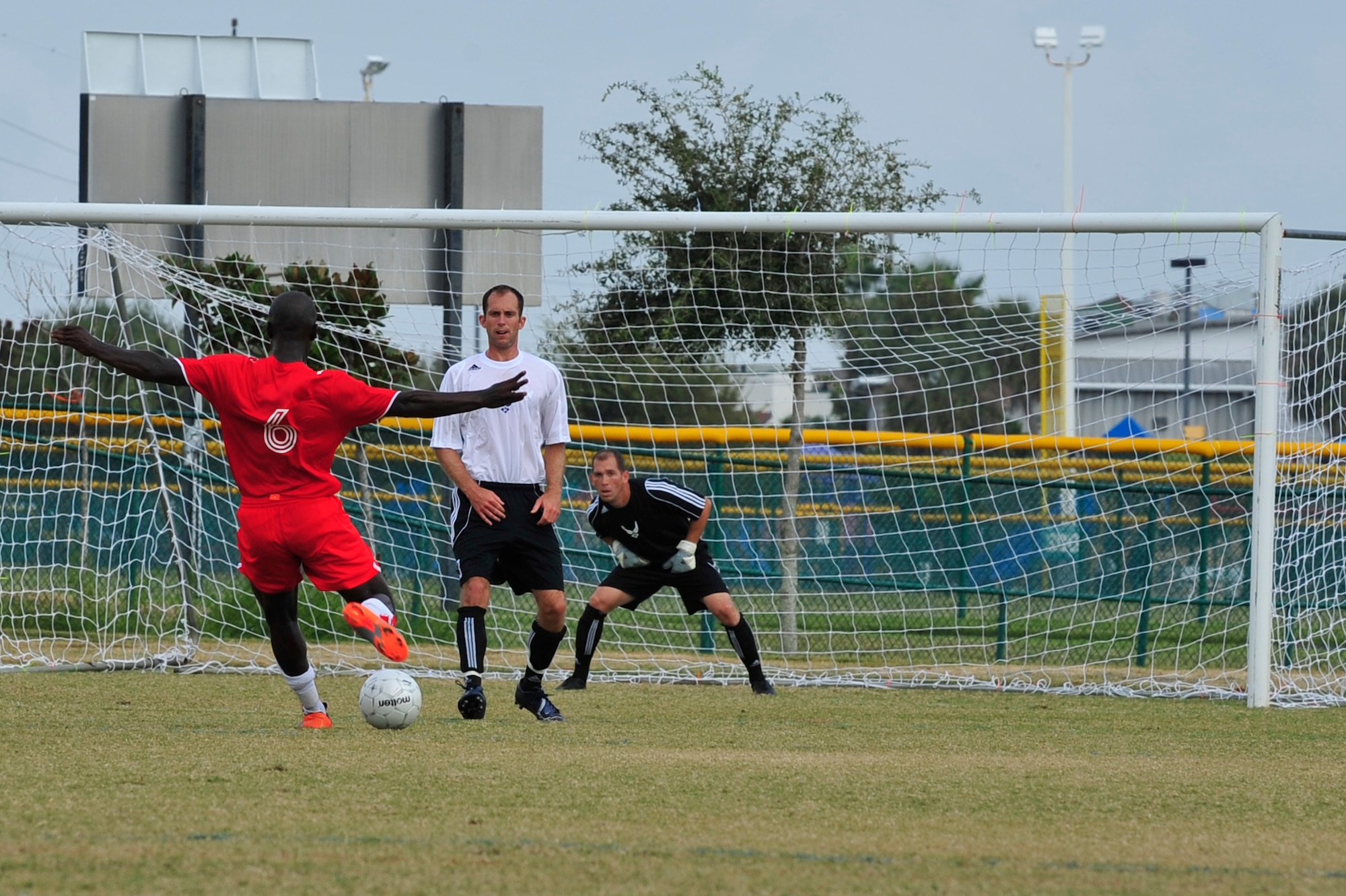 U.S. Marine Corps Sgt. Rodolfo Ayala, takes a shot on the goal while U.S. Air Force Capt. David Schill, a defender for the Air Force Soccer team, and TSgt. Patrick Nicholos, goalie, try to block during an Armed Forces Men's Soccer Championship game at Morgan Sports Complex, Destin, Fla., Oct. 24, 2010. The Armed Forces Championships are conducted by the Armed Forces Sports council for the purpose of promoting, understanding, goodwill, and competition among the Armed Services. (DoD Photo by Staff Sgt. Stephanie Jacobs/RELEASED)
