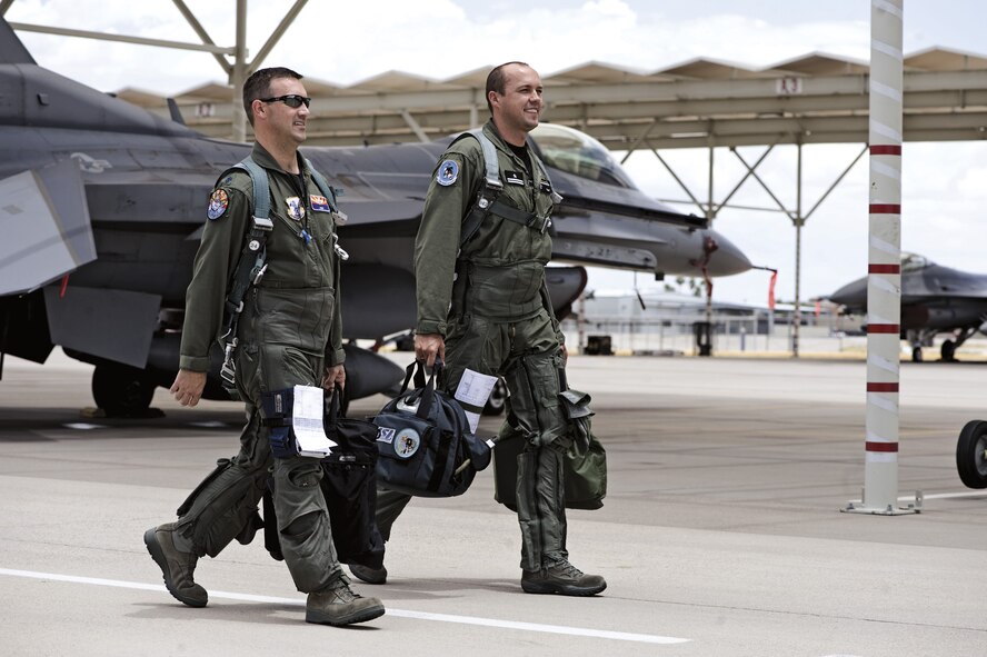 Lt. Col. Chuck Blank, left, and Maj. Pawell Marcinkowski walk to their jets before a training mission. Lt. Col. Blank is the director of operations and an instructor with the 152nd Fighter Squadron and Maj. Marcinkowski is a Polish air force student in Instructor pilot upgrade training. After graduation, Major  Marcinkowski will return to Poland and train pilots there. (U.S. Air Force photo/ Master Sgt. Jack Braden)