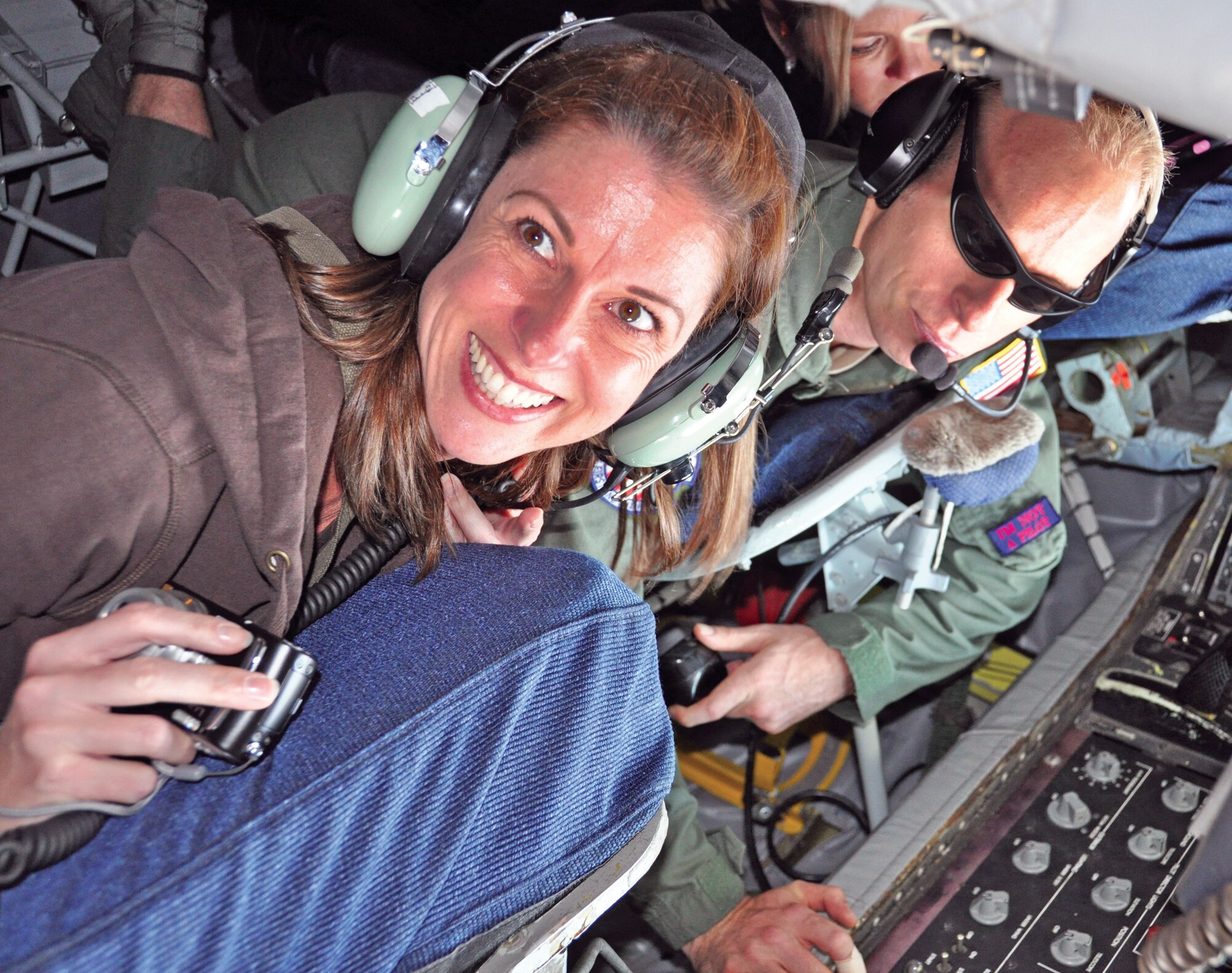 Master Sgt. Dorian Johnson, 336th Air Refueling Squadron, prepares for refueling while Tina Hellwig, senior buyer for Core-Mark International, Inc., watches. Hellwig said she “felt like a kid in a candy store” during the Oct. 16 flight. (U.S. Air Force photo by Linda Welz)