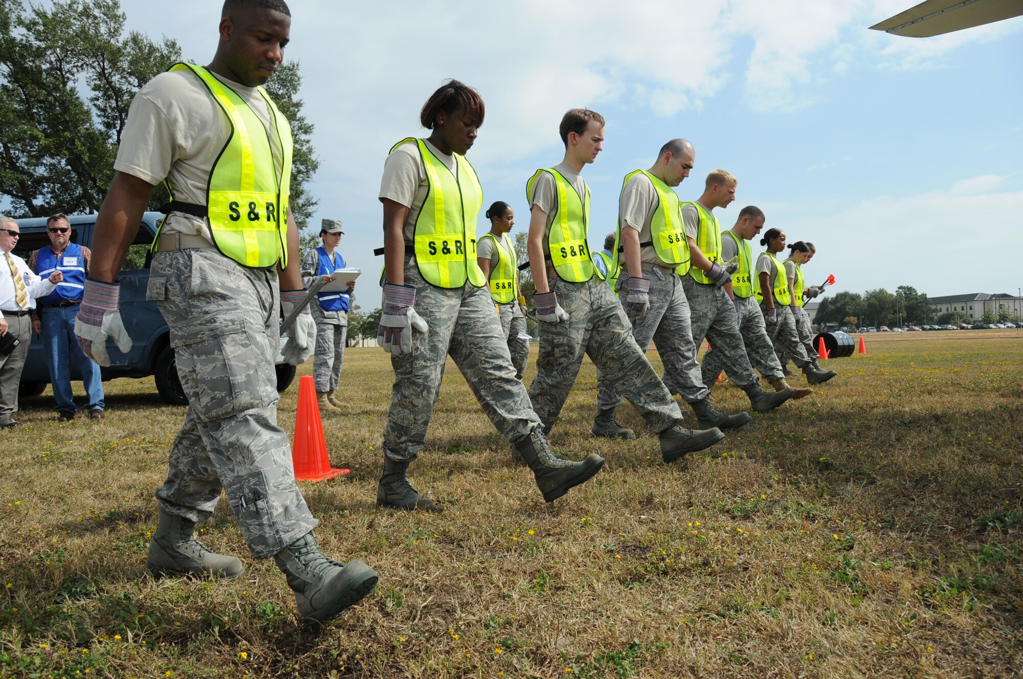 Senior Airman Jeremy Journigan, Staff Sgt. Jacquelyn Jones, Airman 1st Class Evan Compton, and Airman 1st Class Welson Portillo, 81st Force Support Squadron begin their search as part of Search and Recovery team in Tuesday's major accident response exercise.  During the exercise a C-130J made a hard landing, lost engine power and crashed into a six-passenger van, coming to rest on the Triangle track north of Alho Manor.  The scenario also included a spill from chemicals on the aircraft, hydraulic fluid and JP-8 fuel.  Three people "died" and 30 were "injured" in the accident, part of this week's Air Education and Training Command Compliance Inspection.  (U.S. Air Force photo by Kemberly Groue)