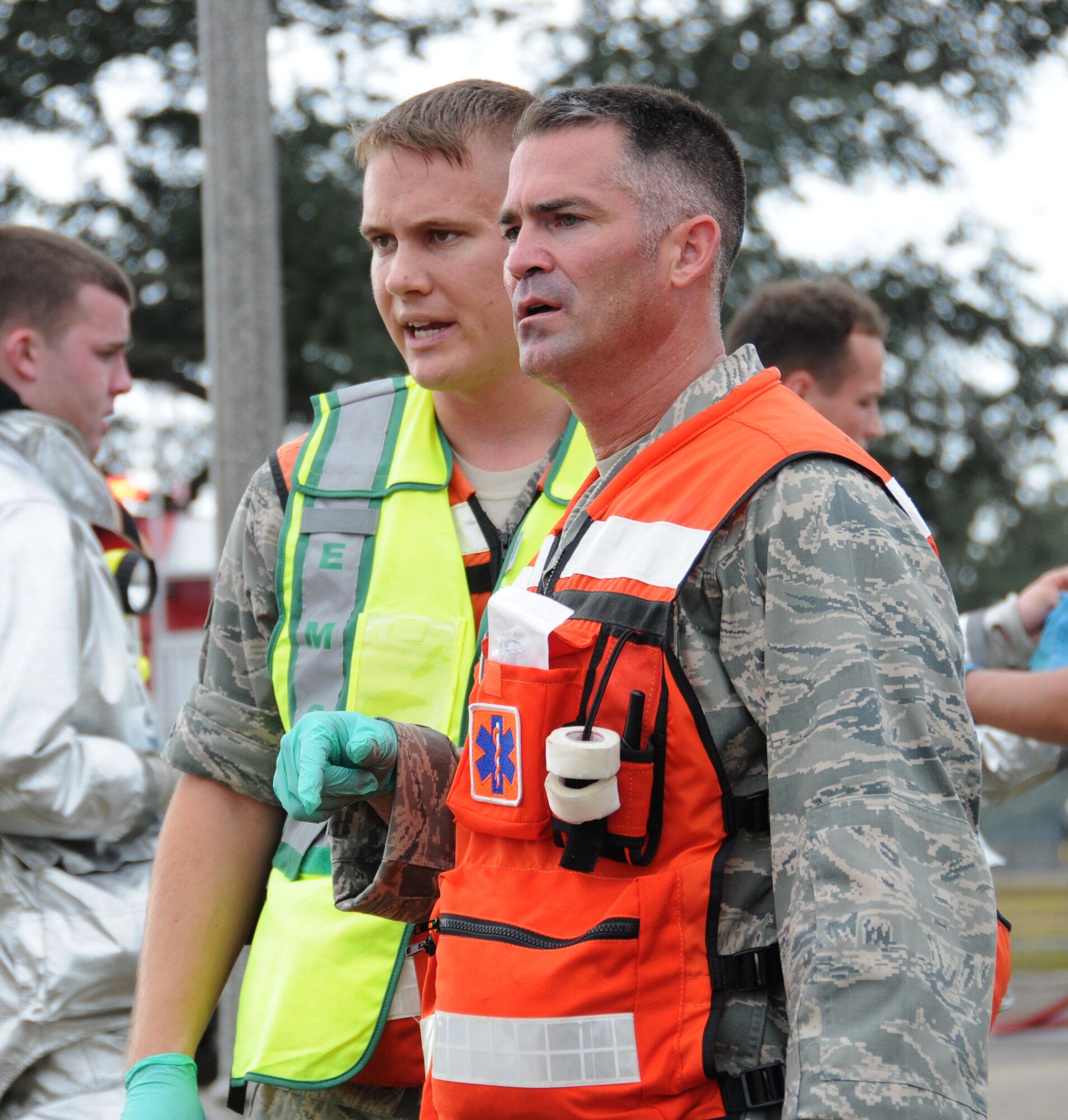 Senior Airman John Reed, 81st Aerospace Medical Squadron and Maj. Paul Langevin, tactical on scene coordinator,  81st AMDS discuss which victims to place in which triage areas in Tuesday's major accident response exercise.  During the exercise a C-130J made a hard landing, lost engine power and crashed into a six-passenger van, coming to rest on the Triangle track north of Alho Manor.  The scenario also included a spill from chemicals on the aircraft, hydraulic fluid and JP-8 fuel.  Three people "died" and 30 were "injured" in the accident, part of this week's Air Education and Training Command Compliance Inspection.  (U.S. Air Force photo by Kemberly Groue)
