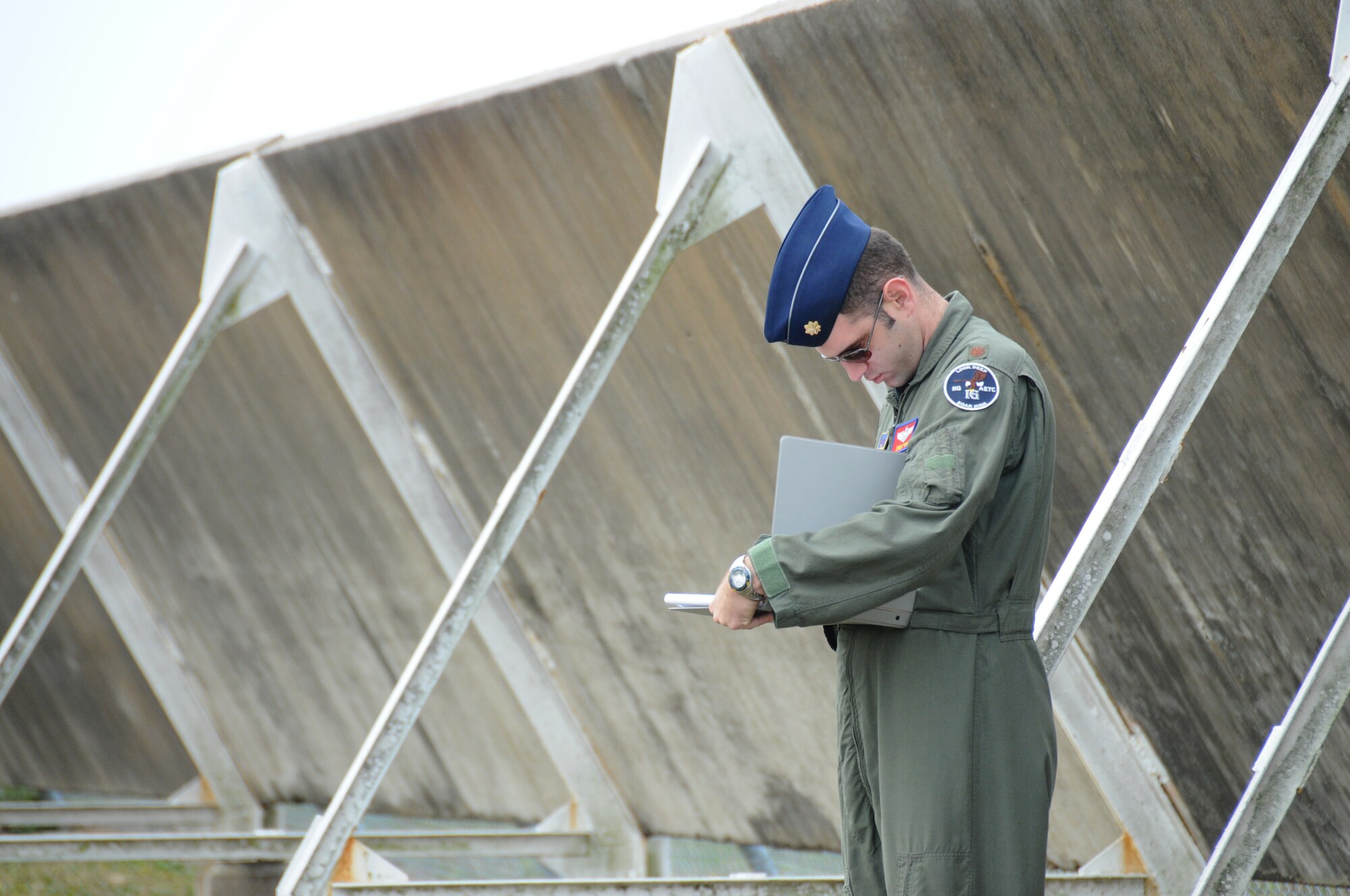 Maj. Jeremy Ponn, a member of the Inspector General team takes notes in Tuesday's major accident response exercise.  During the exercise a C-130J made a hard landing, lost engine power and crashed into a six-passenger van, coming to rest on the Triangle track north of Alho Manor.  The scenario also included a spill from chemicals on the aircraft, hydraulic fluid and JP-8 fuel.  Three people "died" and 30 were "injured" in the accident, part of this week's Air Education and Training Command Compliance Inspection.  (U.S. Air Force photo by Kemberly Groue)