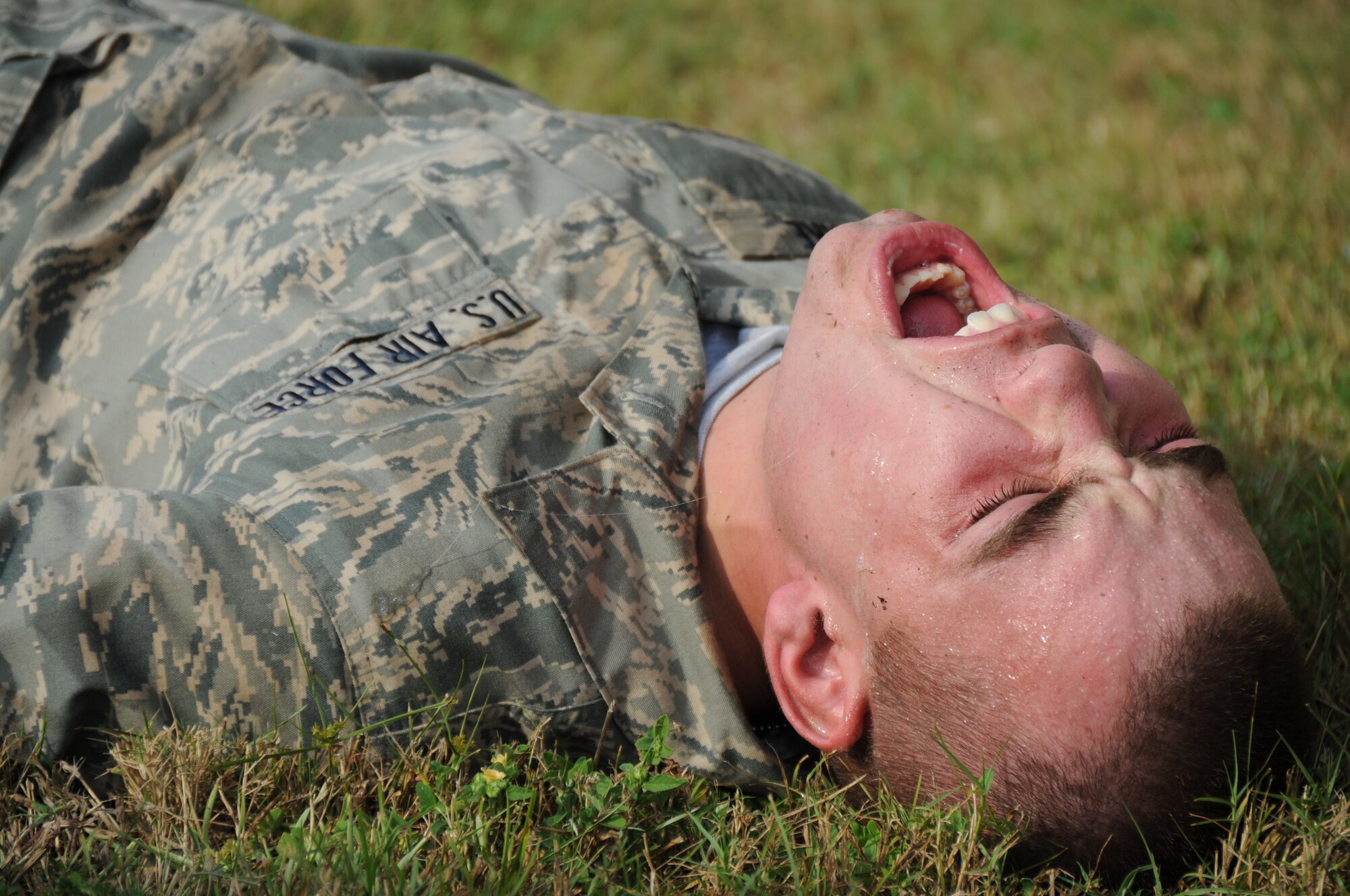 Airman Basic Kody Sumter, a 334th Training Squadron student screams in Tuesday's major accident response exercise.  During the exercise a C-130J made a hard landing, lost engine power and crashed into a six-passenger van, coming to rest on the Triangle track north of Alho Manor.  The scenario also included a spill from chemicals on the aircraft, hydraulic fluid and JP-8 fuel.  Three people "died" and 30 were "injured" in the accident, part of this week's Air Education and Training Command Compliance Inspection.  (U.S. Air Force photo by Kemberly Groue)