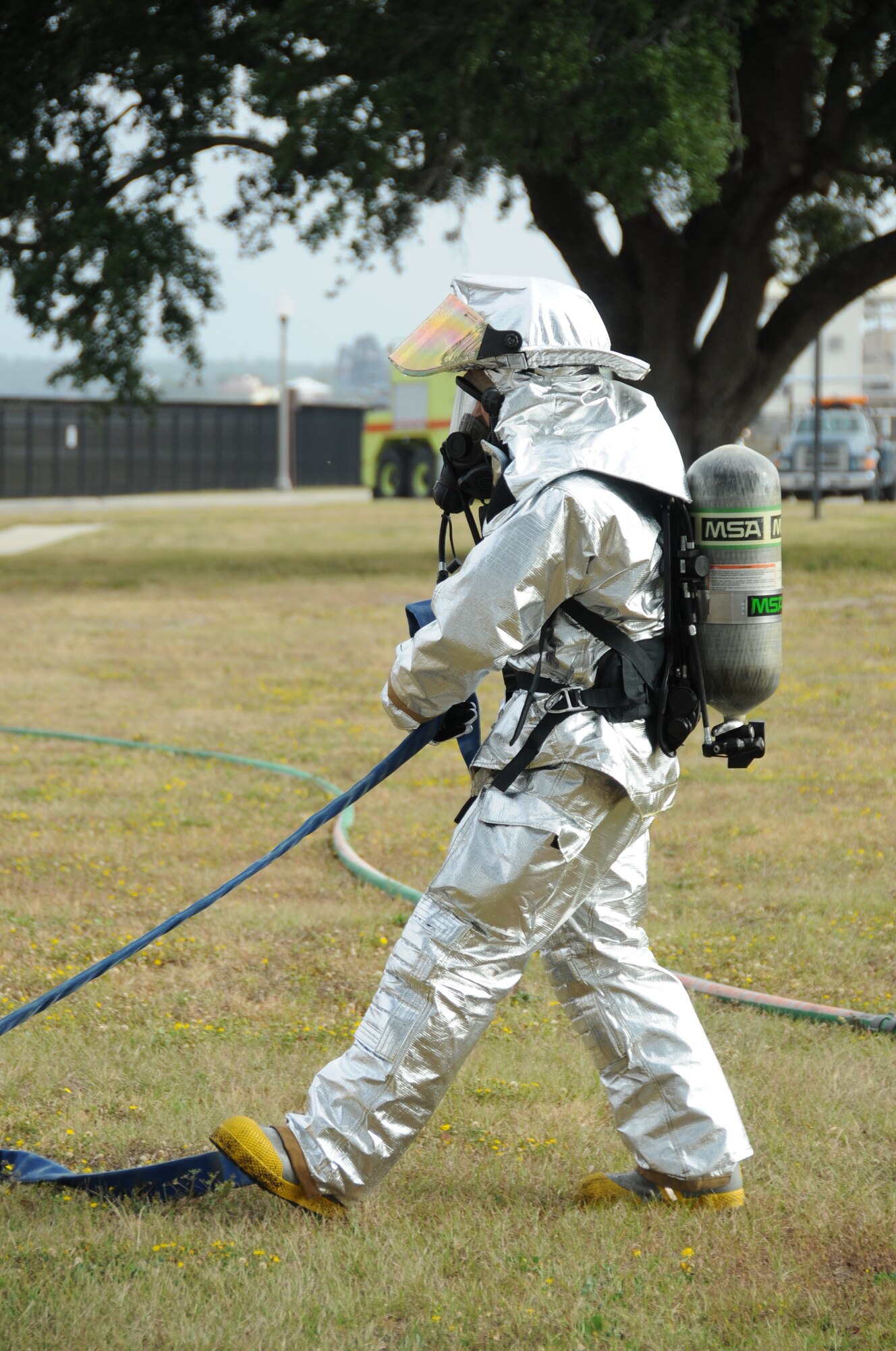 Keesler firefighter responds on scene in Tuesday's major accident response exercise.  During the exercise a C-130J made a hard landing, lost engine power and crashed into a six-passenger van, coming to rest on the Triangle track north of Alho Manor.  The scenario also included a spill from chemicals on the aircraft, hydraulic fluid and JP-8 fuel.  Three people "died" and 30 were "injured" in the accident, part of this week's Air Education and Training Command Compliance Inspection.  (U.S. Air Force photo by Kemberly Groue)