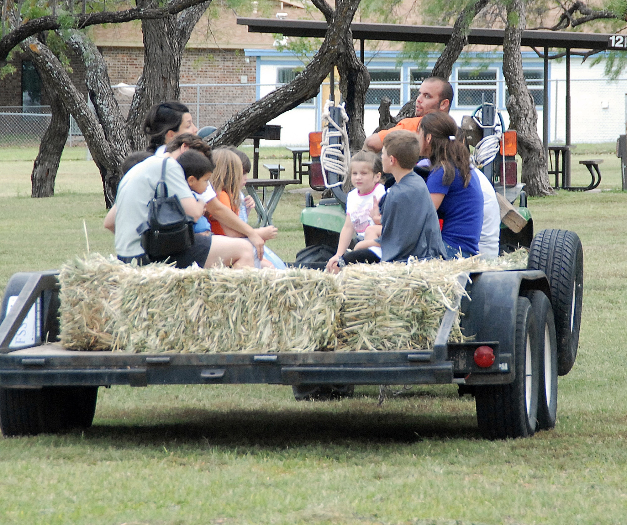 GOODFELLOW AIR FORCE BASE, Texas -- Families enjoy a hay ride at the Rec Camp at Lake Nasworthy Oct. 25.  Other Halloween activities put on by the 17th Force Support Squadron include a Booktacular Scary Story Time Oct. 29 for ages youth 4-12 at the base library and a Boo Bash Oct. 30 from 7:30-11 p.m. for individuals age 18 and older at the Event Center. (U.S. Air Force photo/Connie Hempel)