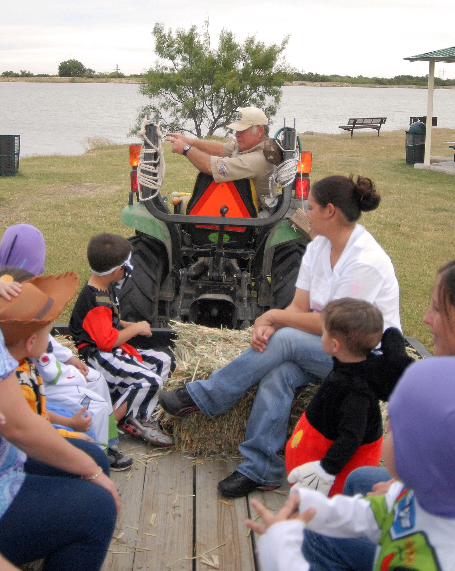 GOODFELLOW AIR FORCE BASE, Texas -- Families enjoy a hay ride at the Rec Camp at Lake Nasworthy Oct. 25.  Other Halloween activities put on by the 17th Force Support Squadron include a Booktacular Scary Story Time Oct. 29 for ages youth 4-12 at the base library and a Boo Bash Oct. 30 from 7:30-11 p.m. for individuals age 18 and older at the Event Center. (U.S. Air Force photo/Connie Hempel)