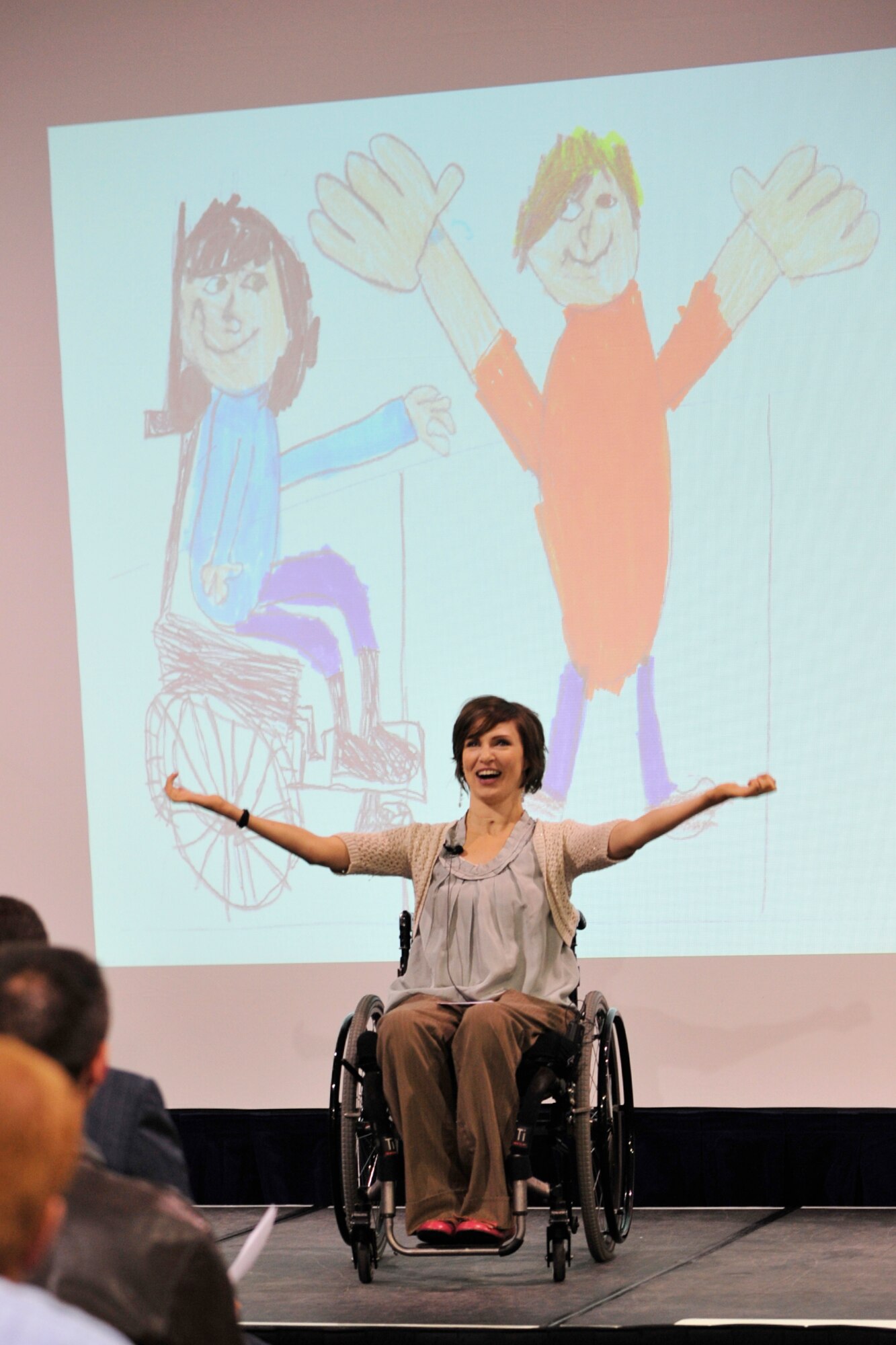 Meg Johnson, Miss Wheelchair co-proprietor, shares her nephew's drawing at the Combined Federal Campaign launch on Oct. 14 as she talks about his attempts to make sure his Aunt Meg was OK. Hill Air Force Base combined its kick-off with the Intermountain CFC in an event at the Hill Aerospace Museum. (U.S. Air Force photo by: Kim Cook)