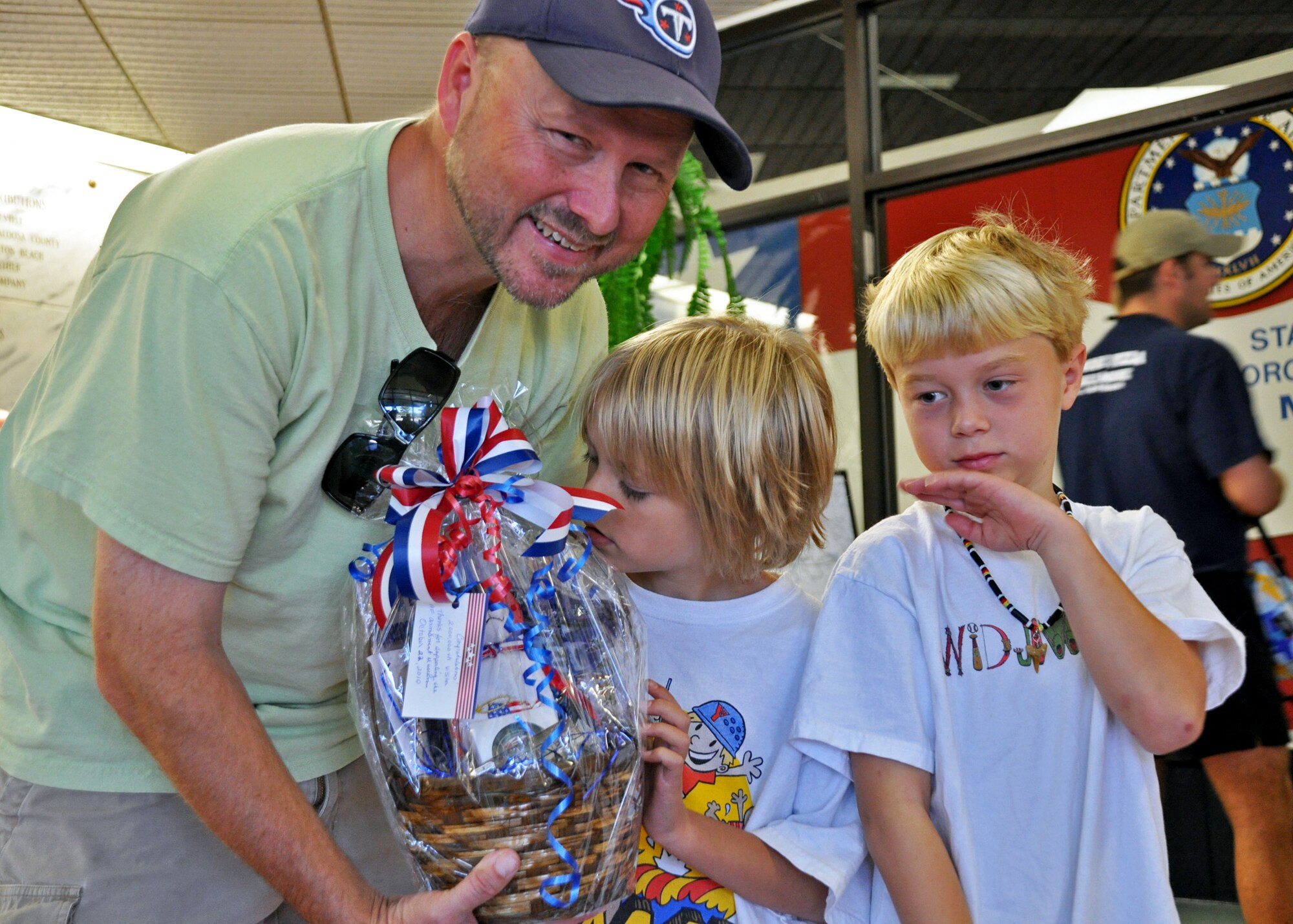 Devin Wells, pictured here with his son Matthew and friend Anthony Smith, was the two millionth visitor to the Air Armament Museum Oct. 22.  The museum reached that number 34 years after opening in 1976.  The museum averages 400 visitors a day.  (U.S. Air Force photo/Ashley M. Wright)