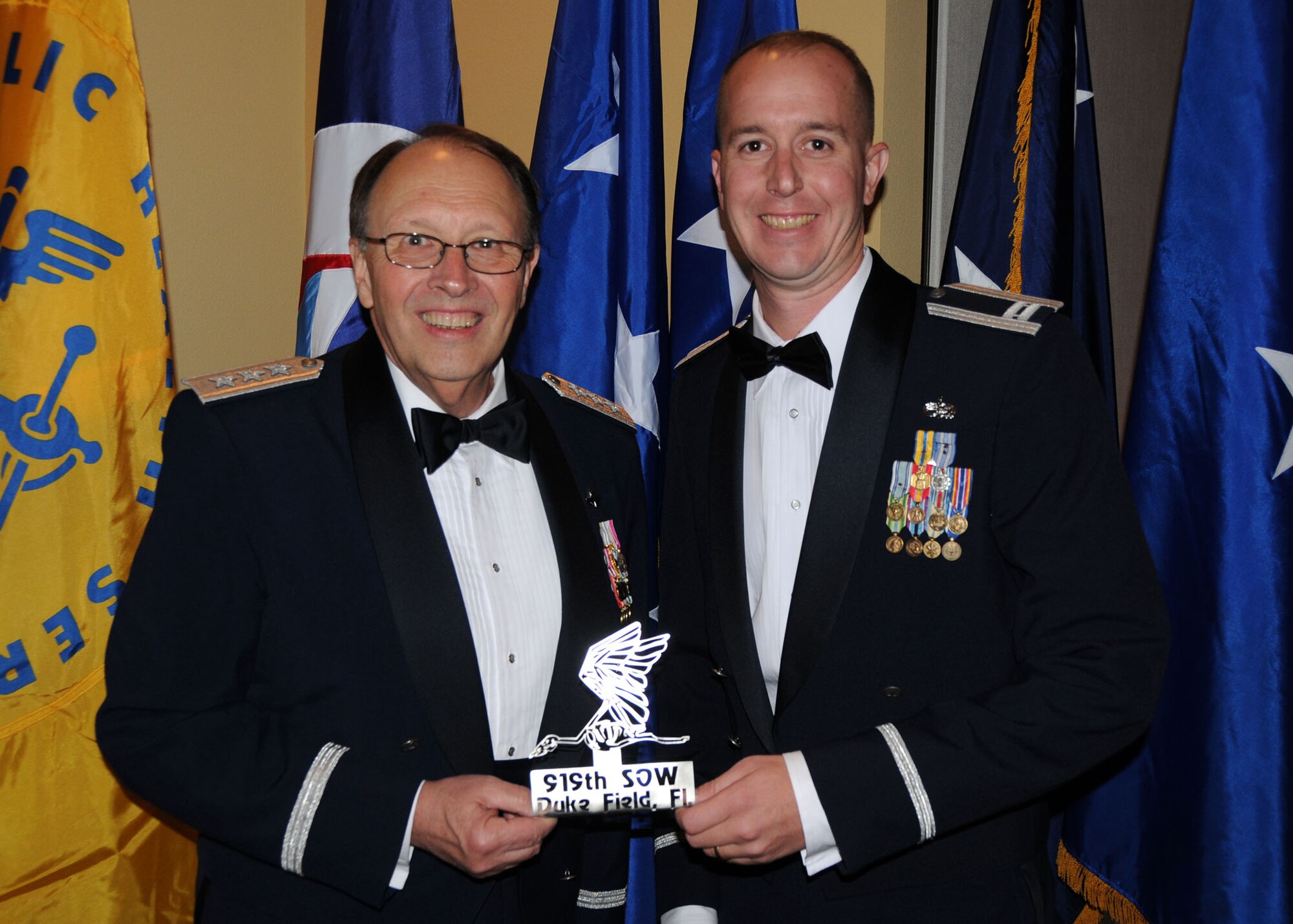 Captain Ronald Vander Kooy, 919th Aircraft Maintenance Squadron, presents Lt. Gen. Charles E. Stenner, Jr. with a memento from Duke Field at the Reserve Officers Association banquet in Fort Walton Beach, Fla., Oct. 23. General Stenner was a guest speaker at this year's annual banquet.  He spoke on the future direction and leadership of the Air Force Reserve and its important role in America's overall military readiness. (U.S. Air Force Photo/Staff Sgt. Jon McCallum)
