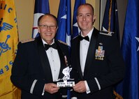 Captain Ronald Vander Kooy, 919th Aircraft Maintenance Squadron, presents Lt. Gen. Charles E. Stenner, Jr. with a memento from Duke Field at the Reserve Officers Association banquet in Fort Walton Beach, Fla., Oct. 23. General Stenner was a guest speaker at this year's annual banquet.  He spoke on the future direction and leadership of the Air Force Reserve and its important role in America's overall military readiness. (U.S. Air Force Photo/Staff Sgt. Jon McCallum)
