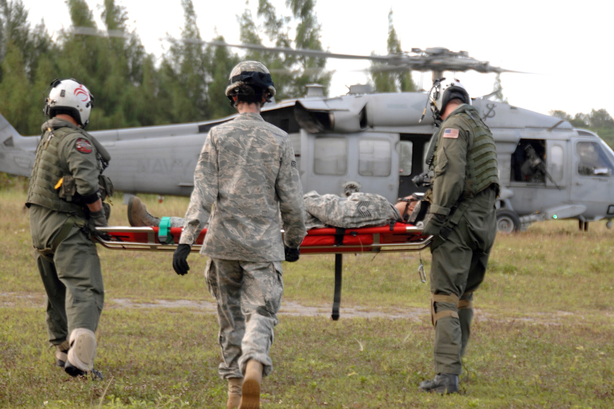 Servicemembers assigned to the 36th Mobility Response Squadron and HSC-25 conduct medical evacuation training Oct. 13, 2010, at Northwest Field, Guam. The joint field training exercise was performed in an effort to interchange and familiarize themselves with each other's tactics, techniques and procedures to be able to interoperate and conduct joint humanitarian assistance/disaster relief missions in the Pacific region. (U.S. Air Force photo/Airman 1st Class Anthony Jennings) 