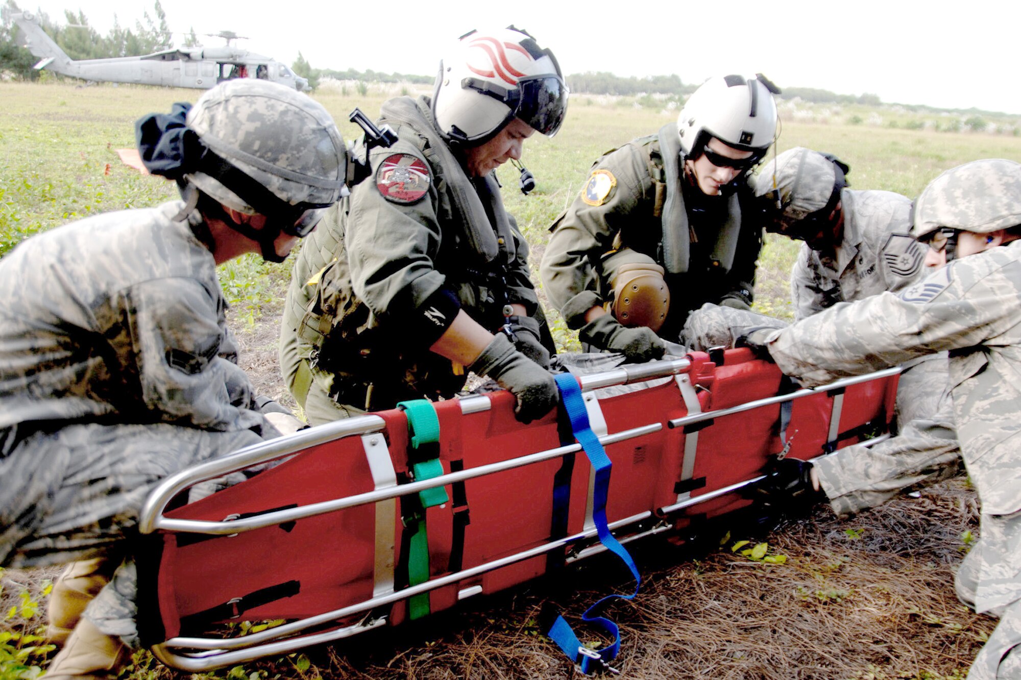 Servicemembers assigned to the 36th Mobility Response Squadron and HSC-25 conduct medical evacuation training Oct. 13, 2010, at Northwest Field, Guam. The joint field training exercise was performed in an effort to interchange and familiarize themselves with each other's tactics, techniques and procedures to be able to interoperate and conduct joint humanitarian assistance/disaster relief missions in the Pacific region. (U.S. Air Force photo/Airman 1st Class Anthony Jennings) 