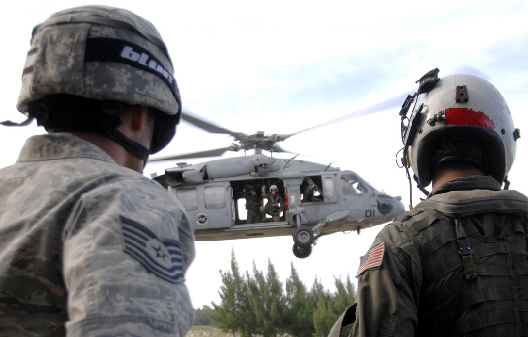 Servicemembers assigned to the 36th Mobility Response Squadron and HSC-25 conduct medical evacuation training Oct. 13, 2010, at Northwest Field, Guam. The joint field training exercise was performed in an effort to interchange and familiarize themselves with each other's tactics, techniques and procedures to be able to interoperate and conduct joint humanitarian assistance/disaster relief missions in the Pacific region. (U.S. Air Force photo/Airman 1st Class Anthony Jennings) 
