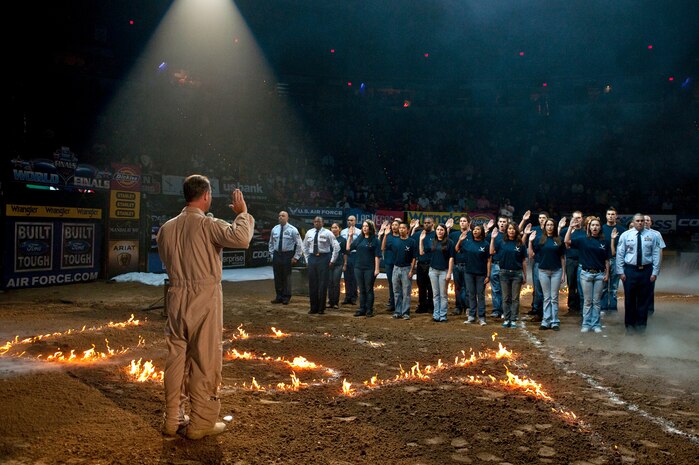 LAS VEGAS -- Lt. Col. James McElhenney, 563rd Rescue Group deputy commander, administers the oath of enlistment to local delayed enlistment program participants during the opening ceremonies at the Professional Bull Riding Finals at the Thomas and Mack Center Oct. 22. Airmen from Nellis Air Force Base were honored for their service to the country during Air Force night at the PBR Finals .  (U.S. Air Force photo / Tech. Sgt. Michael R. Holzworth)