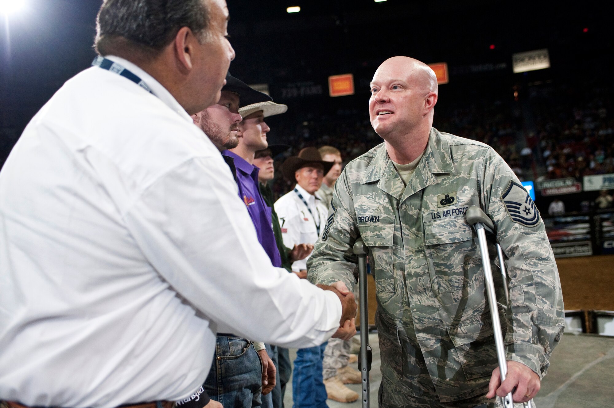LAS VEGAS --  Master Sgt. Jeramie Brown, 99th Air Base Wing Public Affairs broadcast journalist, shakes hands with professional bull riders at the Professional Bull Riding Finals in the Thomas and Mack Center Oct. 22. Airmen from Nellis Air Force Base were honored for their service to the country during Air Force night at the PBR Finals.  (U.S. Air Force photo / Tech. Sgt. Michael R. Holzworth)
