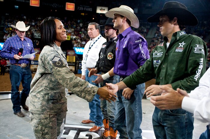 LAS VEGAS--  Master Sgt. Kisha Washington from the 99th Logistics Readiness Squadron shakes hands with professional bull riders at the Professional Bull Riding Finals in the Thomas and Mack Center Oct. 22. Airmen from Nellis Air Force Base were honored for their service to the country during Air Force night at the PBR Finals.  (U.S. Air Force photo / Tech. Sgt. Michael R. Holzworth)
