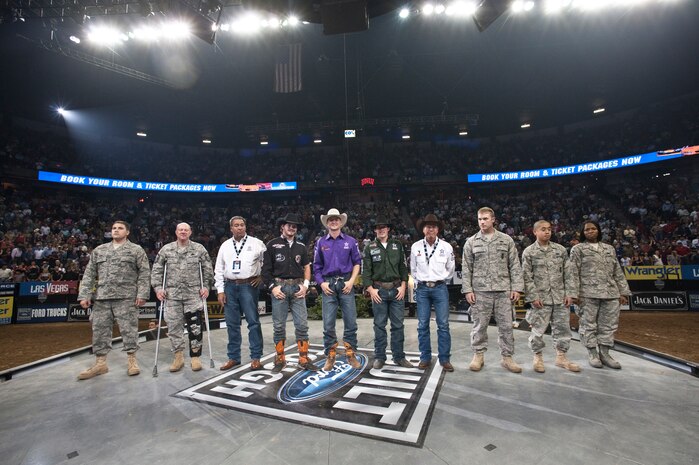 LAS VEGAS --  Airmen from Nellis Air Force Base join with professional bull riders on stage during intermission of the Professional Bull Riding Finals at the Thomas and Mack Center Oct. 22.  The Airmen were honored for their service to the country during Air Force night at the PBR Finals .  (U.S. Air Force photo / Tech. Sgt. Michael R. Holzworth)