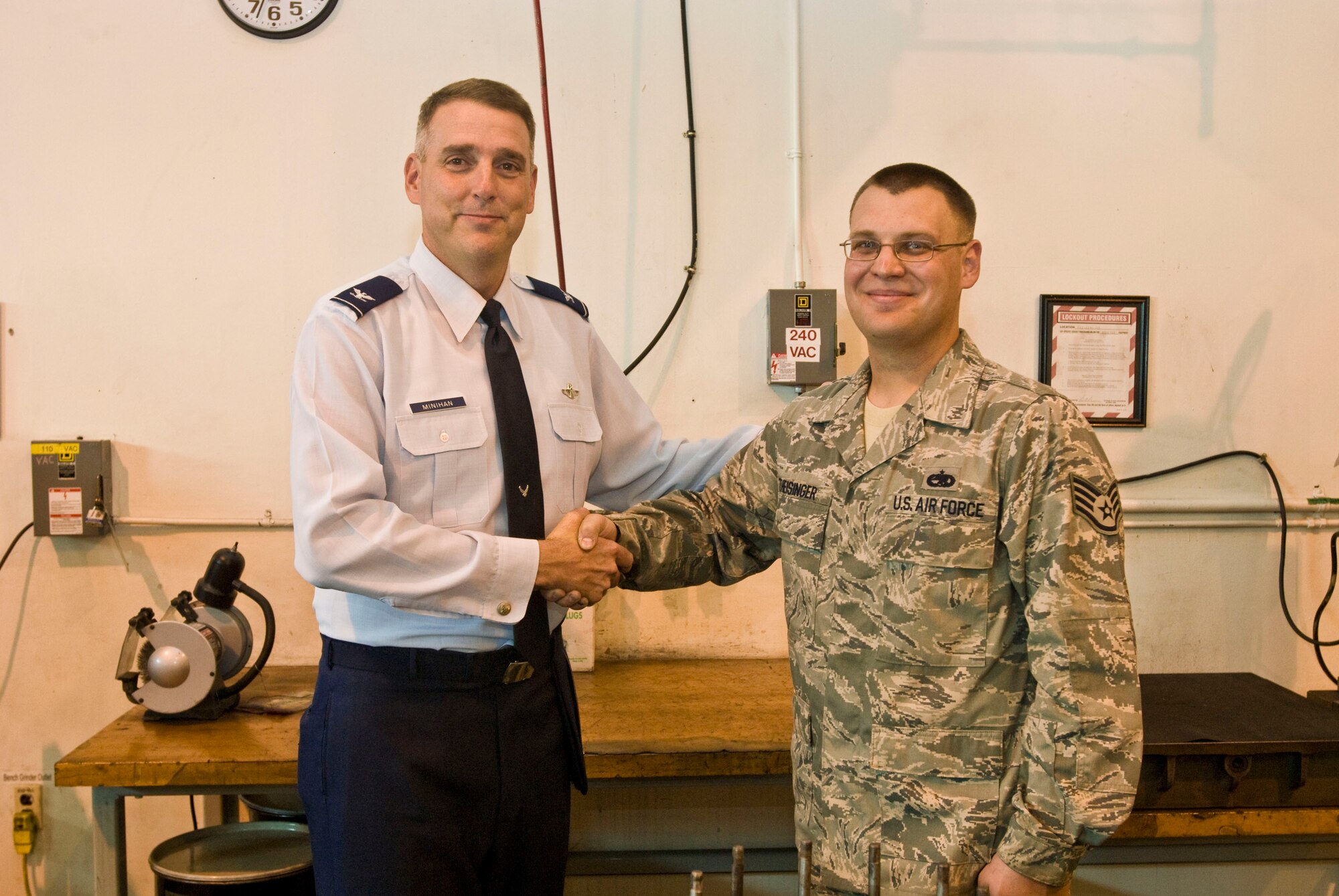 Col. Mike Minihan (left), 19th Airlift Wing commander, presents a coin Oct. 25 to Staff Sgt. Eric Theisinger, 19th Component Maintenance Squadron hydraulic systems craftsman, for his selection as the Combat Airlifter of the Week. Sergeant Theisinger coordinated 25 events and raised more than $7,500 as the Air Force Sergeant’s Association Little Rock Chapter president. (U.S. Air Force photo by Staff Sgt. Nestor Cruz)