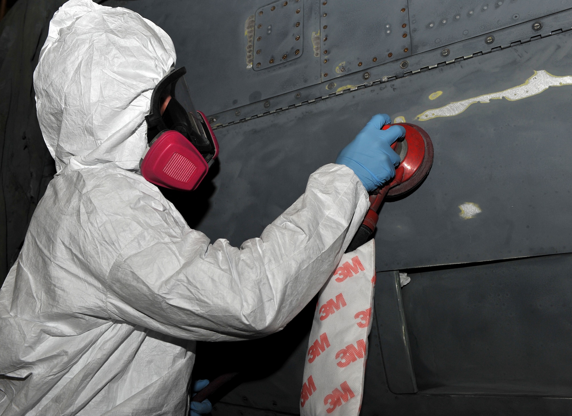 Senior Airman Dakota Phillips, 19th Equipment Maintenance Squadron corrosion control journeyman, sands a C-130 Hercules with a power sander. When certain metals are exposed to oxygen, it creates rust that can lead to corrosion. (U.S. Air Force photo by Senior Airman Gul Crockett)
