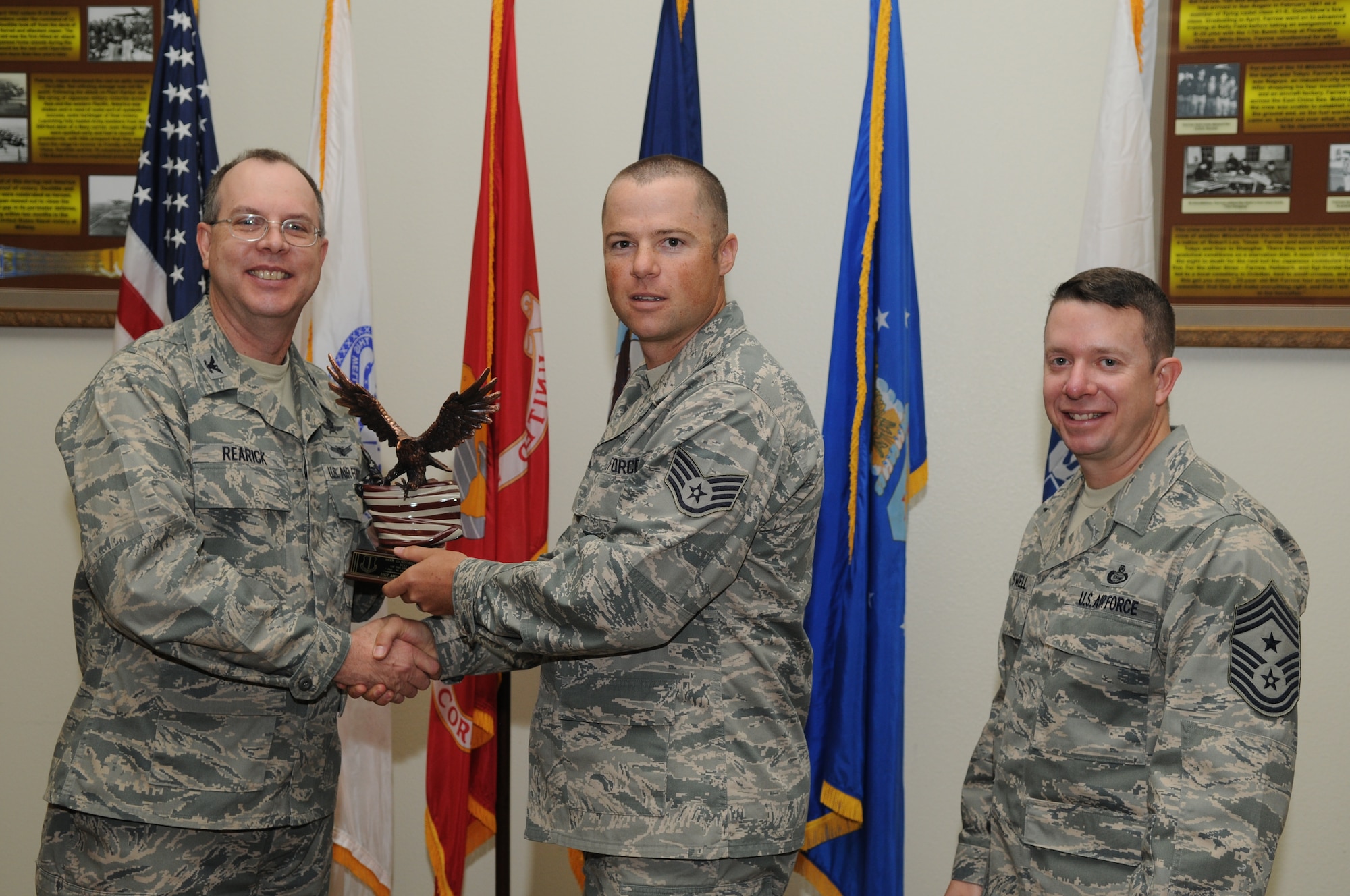 GOODFELLOW AIR FORCE BASE, Texas -- Staff Sgt. Anthony Fridley, 17th Training Group, accepts his Team Goodfellow Noncommissioned Officer of the Quarter Award for the third quarter from Col. David Rearick, 17th Training Wing Vice Commander, and Chief Master Sgt. Brendan Criswell, 17th TRW Command Chief, during the awards breakfast Oct. 26. (U.S. Air Force photo/Airman 1st Class Clayton Lenhardt)