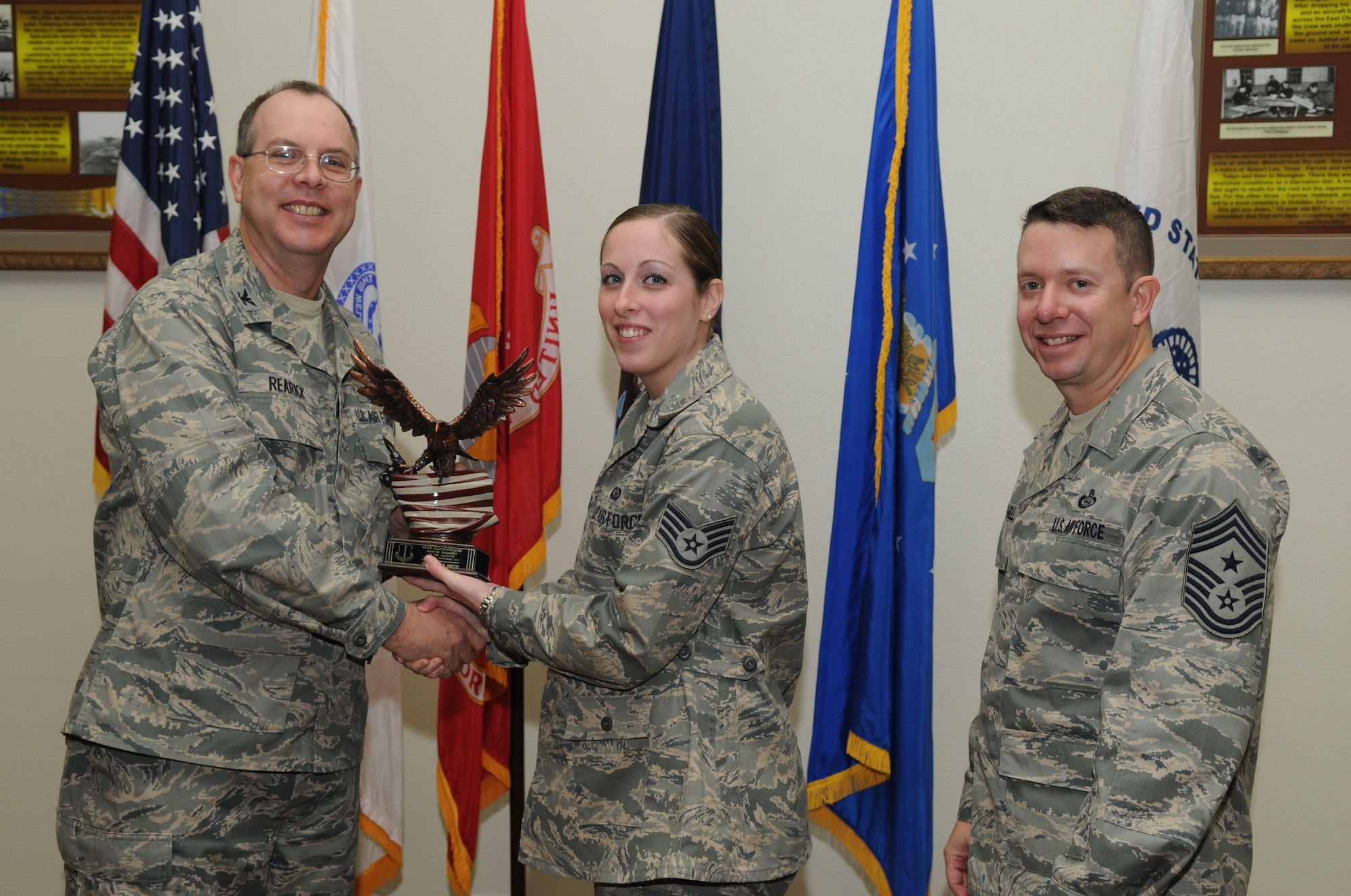 GOODFELLOW AIR FORCE BASE, Texas -- Senior Airman Jeanice Smith, 17th Training Group, accepts her Team Goodfellow Junior Enlisted of the Quarter Award for the third quarter from Col. David Rearick, 17th Training Wing Vice Commander, and Chief Master Sgt. Brendan Criswell, 17th TRW Command Chief, during the awards breakfast Oct. 26. (U.S. Air Force photo/Airman 1st Class Clayton Lenhardt)
