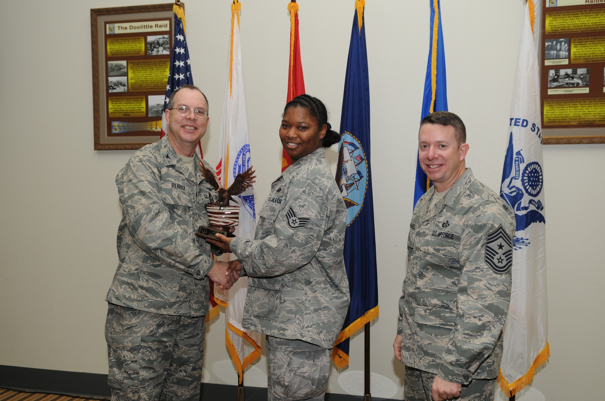 GOODFELLOW AIR FORCE BASE, Texas -- Staff Sgt. Tiffany Howard, 17th Mission Support Group, accepts her Team Goodfellow Volunteer of the Quarter award for the third quarter from Col. David Rearick, 17th Training Wing Vice Commander, and Chief Master Sgt. Brendan Criswell, 17th TRW Command Chief, during the awards breakfast Oct. 26. (U.S. Air Force photo/Airman 1st Class Clayton Lenhardt)
